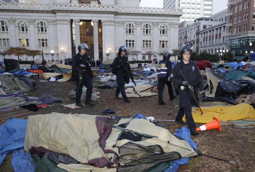 On the morning of November 14th, the police raided the camp. They threw everything into garbage bins: tents, belongings, including the Thinking banner.