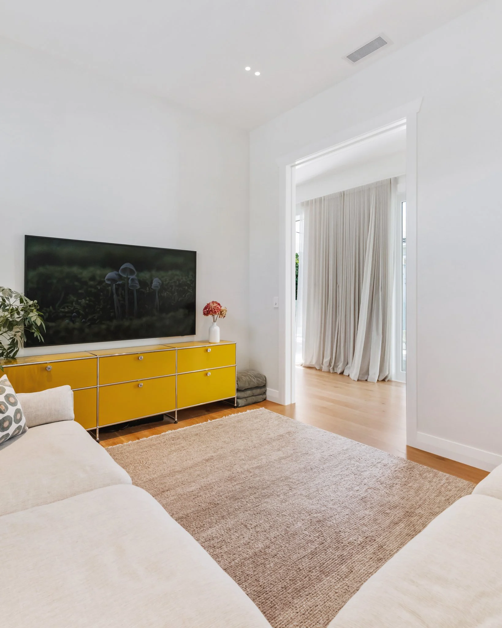 Second lounge with high ceilings, timber floors and view through to main living area — Point Chevalier bungalow renovation by Macfie Architecture Auckland.