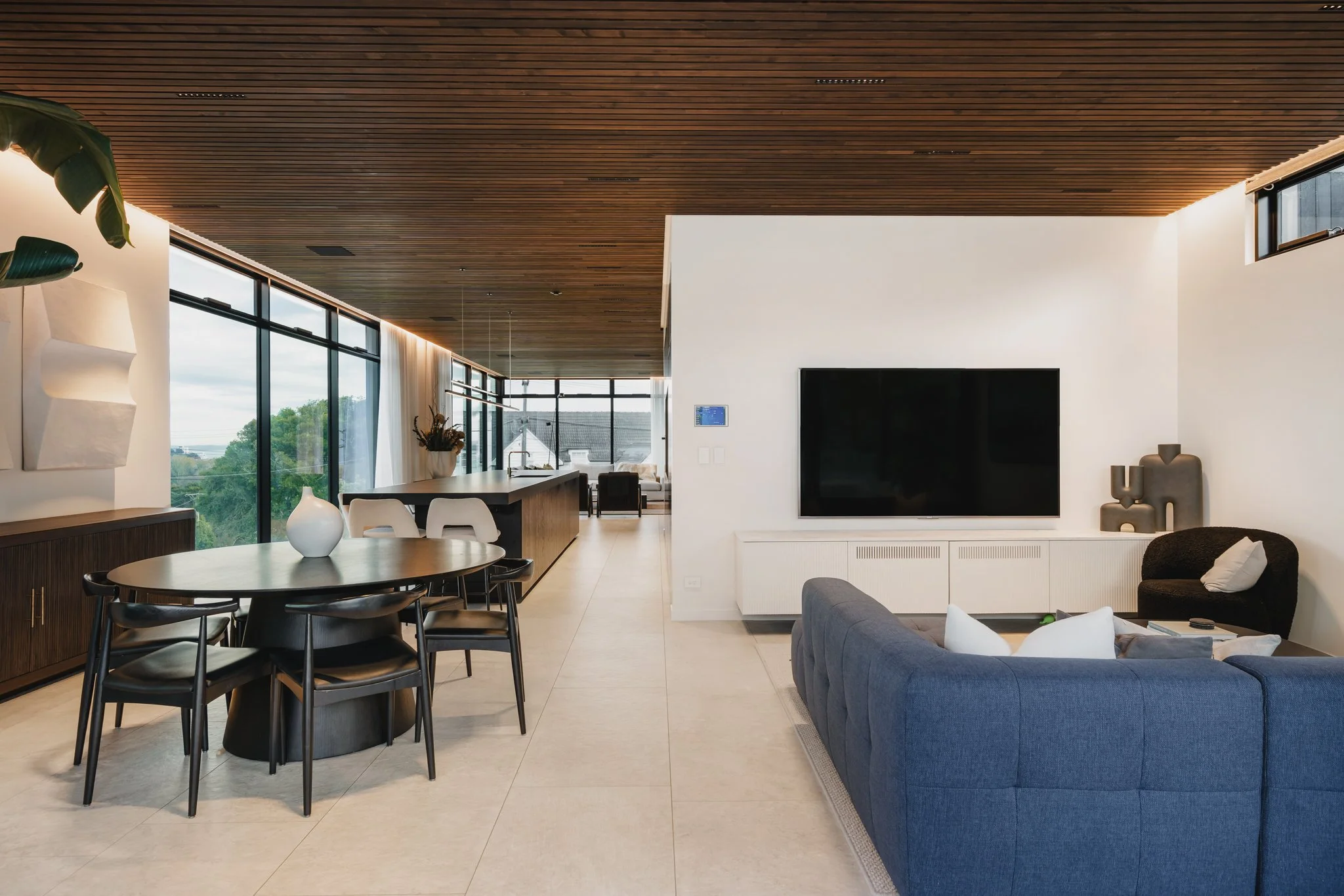 Bespoke new-build interior featuring detailed ceiling wood panelling, inset LED ambient lighting, Italian furniture and stone floors.