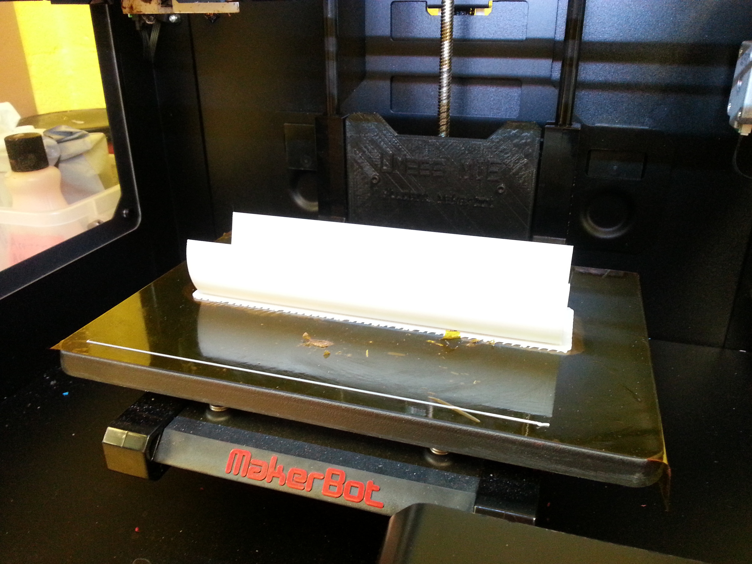 The Makerbot finishing printing on the sample bed. Thanks again to the student run makerspace here on campus for their cooperation in our project.