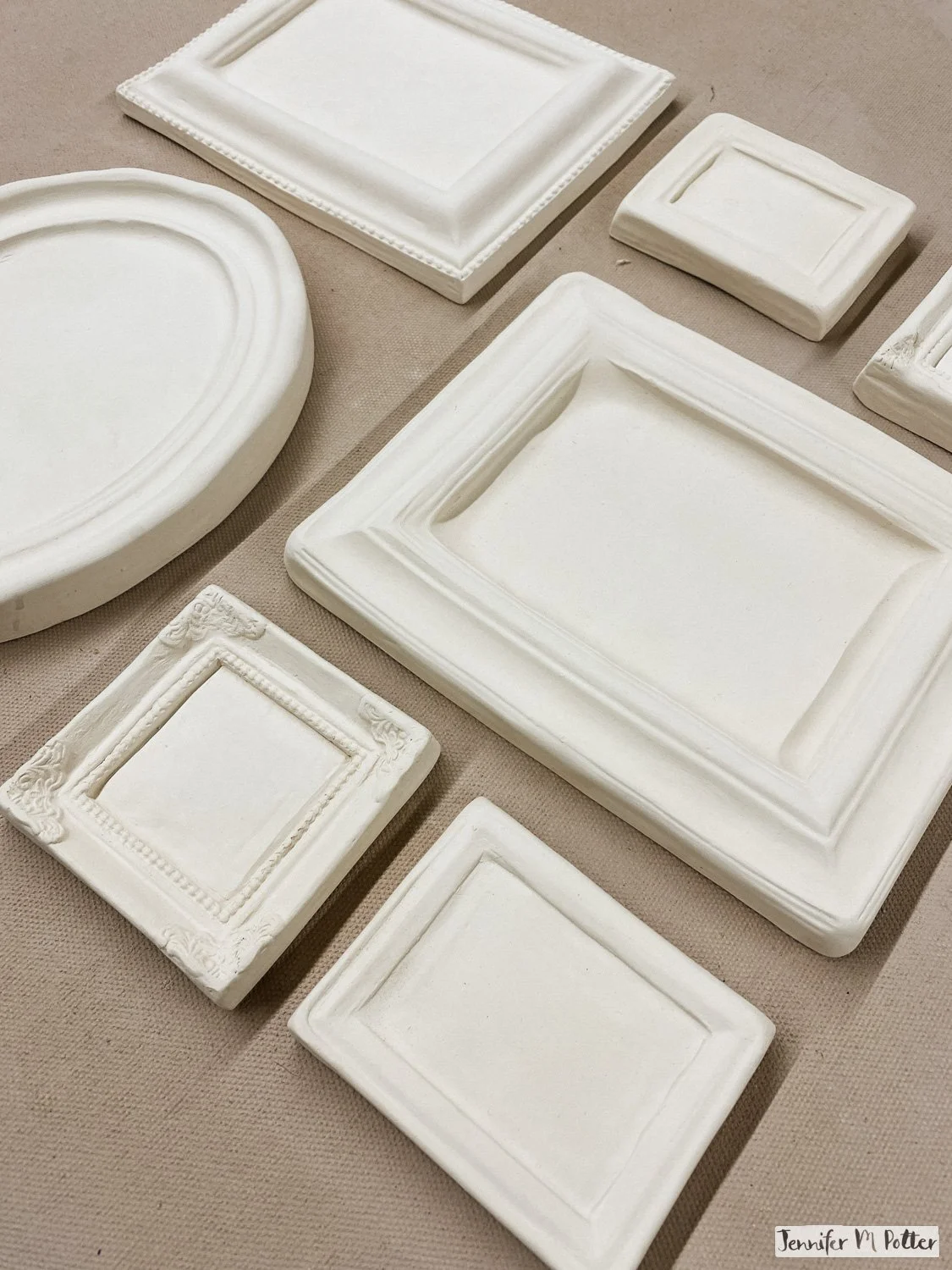 Blank white ceramic framed painting that have been bisque-fired and are ready for paint.