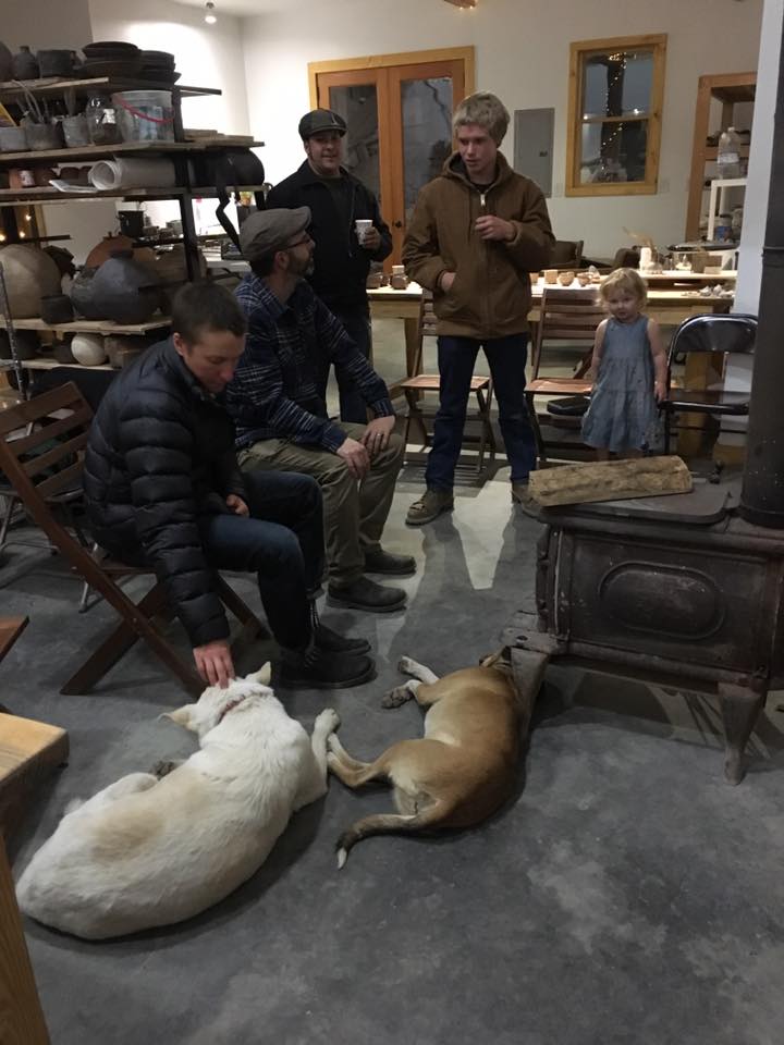 Guests staying warm during a rain storm during the studio sale