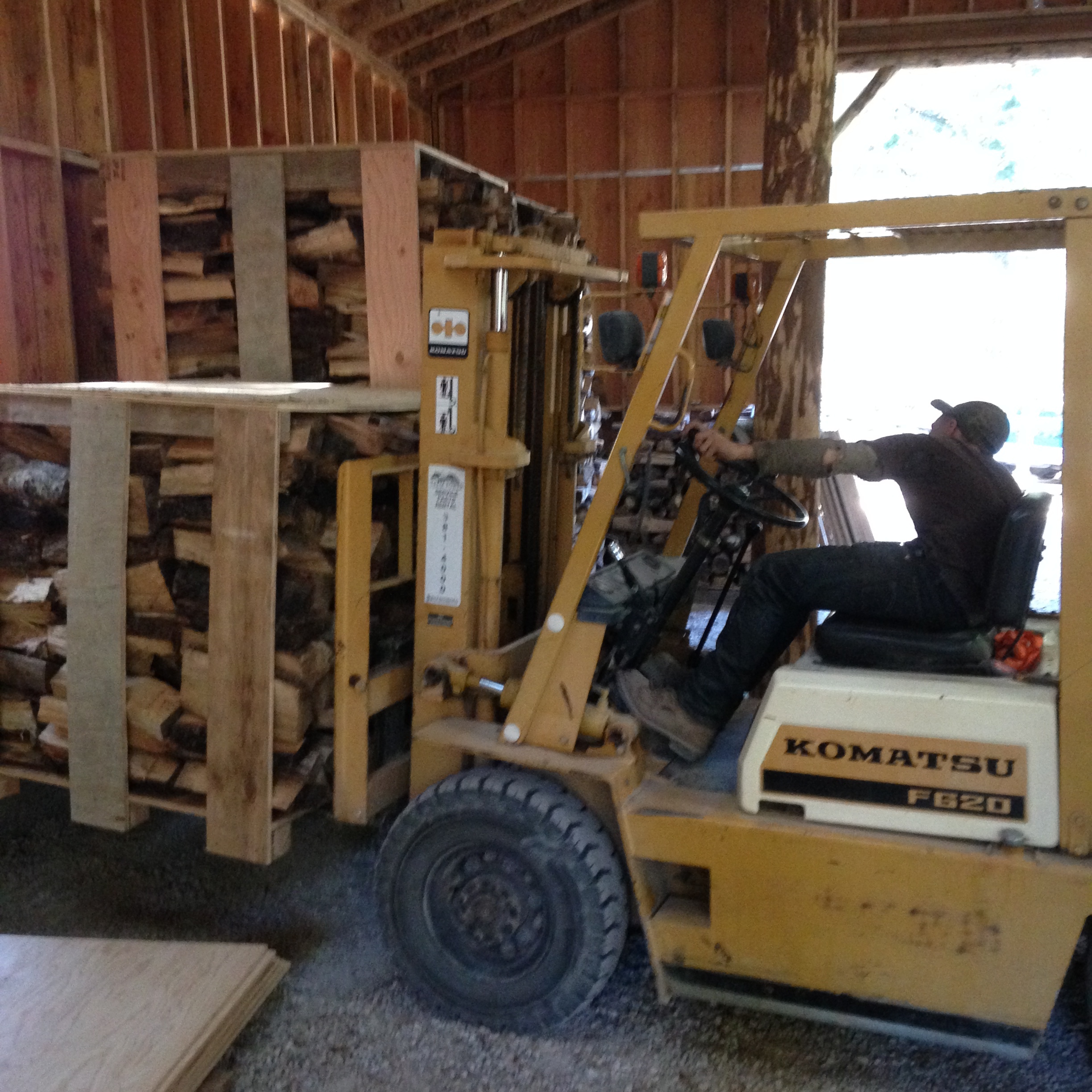 Elliott Parady moving wood around in the barn