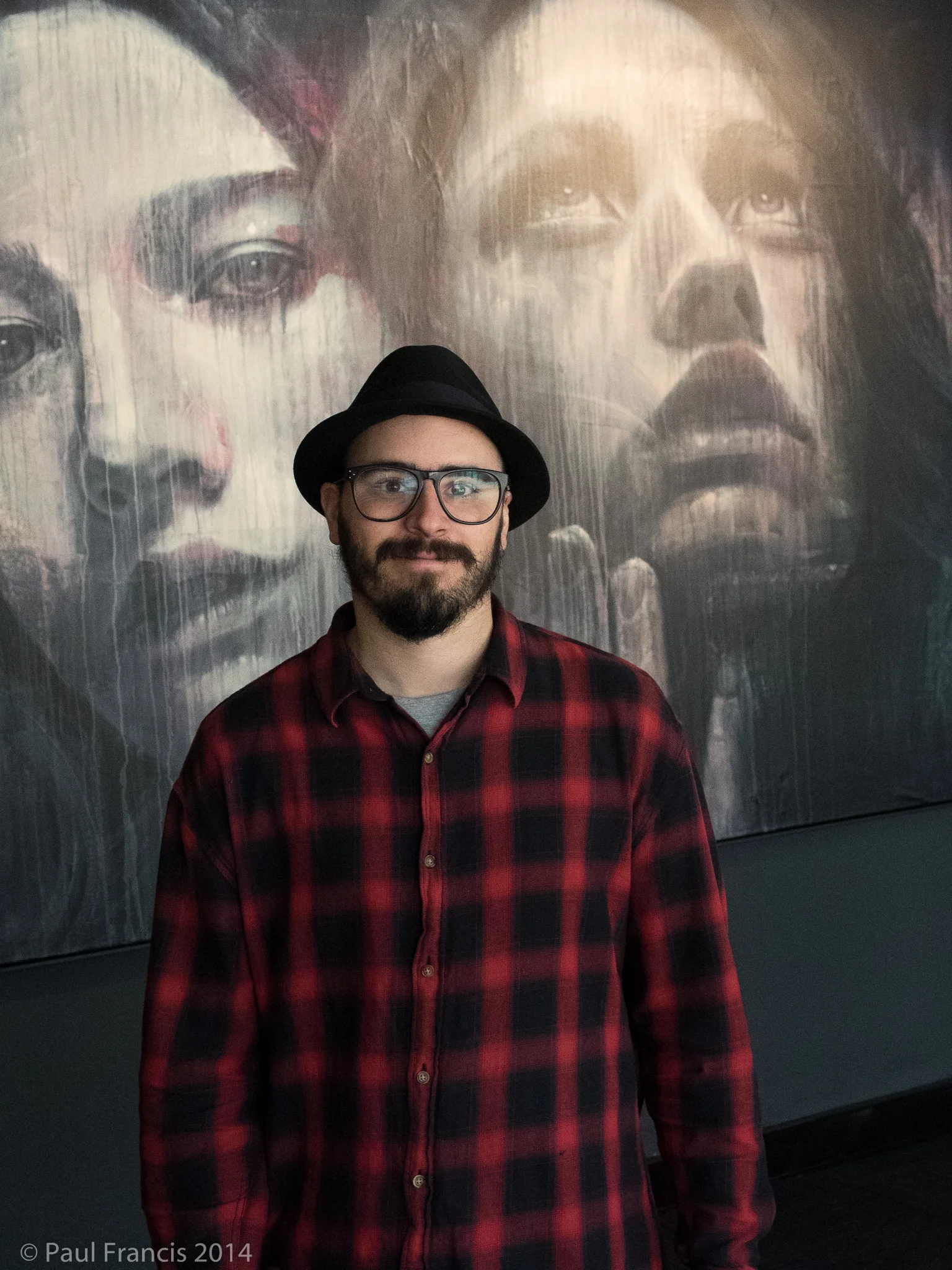 RONE in front of one of his exhibition pieces