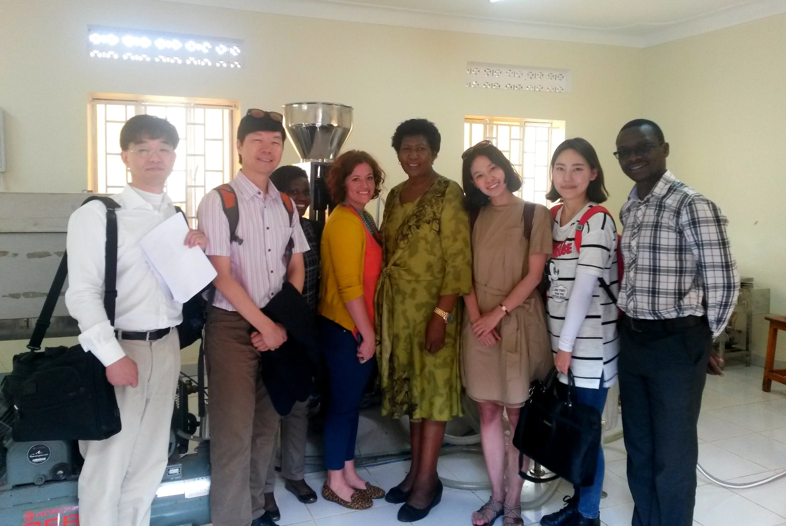 Sujin Kim, Hyun Sang Shin, Kim Jeongtae, Yeji Lee, Liz Lindow and Herbert Kisara with Prudence Ukkonika, the owner of K-Roma, client of the KOICA-Mango Fund joint program, in the Bella Wine factory.