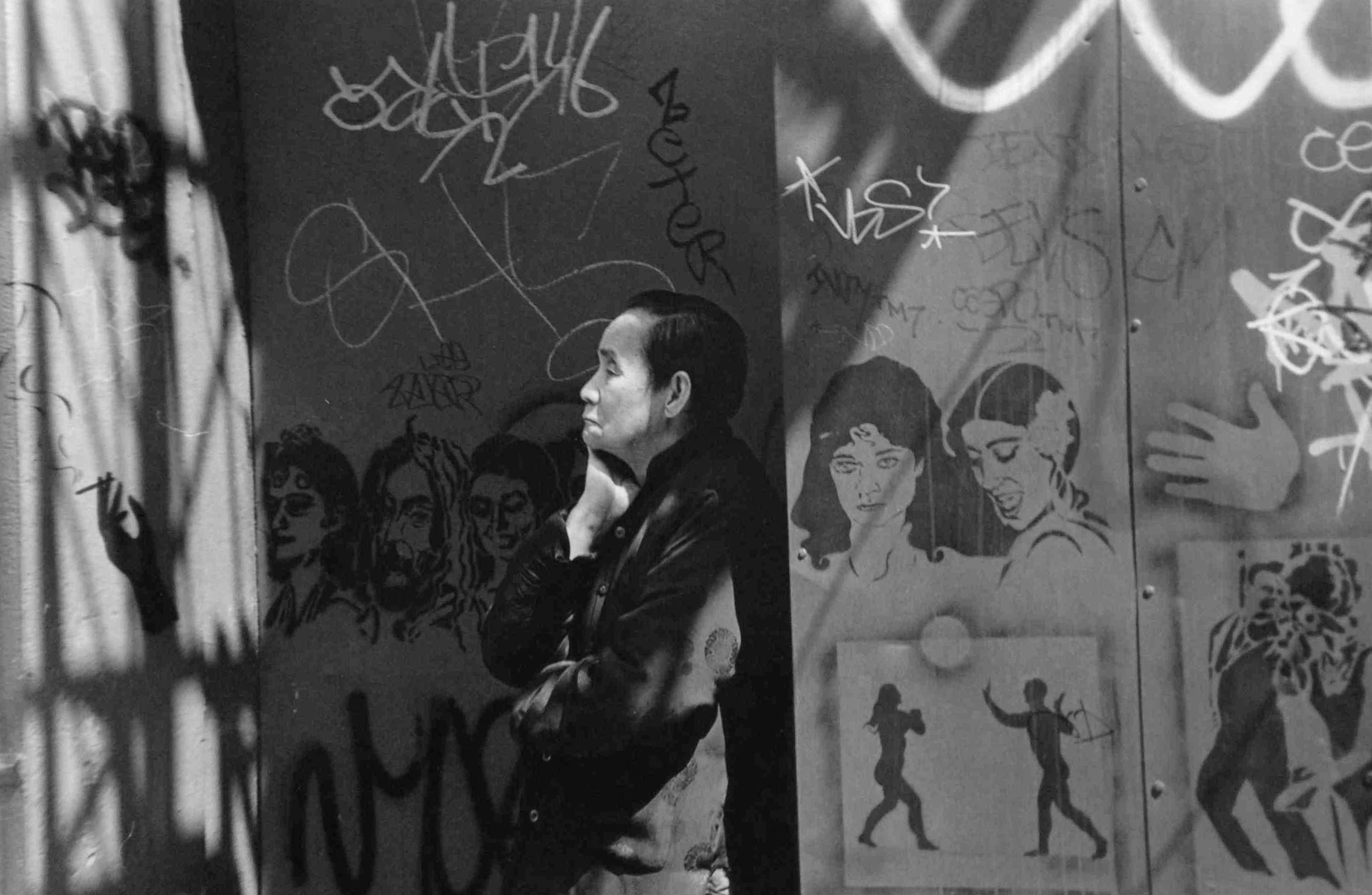   Woman on Mott Street with Graffiti, New York , 1995  Archival Inkjet Print  20 x 13 3/8" &nbsp;$800 