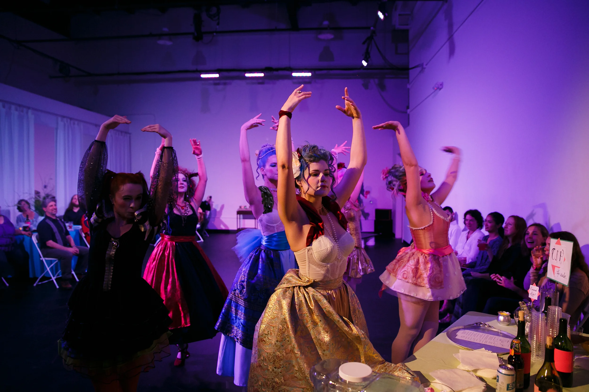 Group of dancers dressed in high fashion French gowns