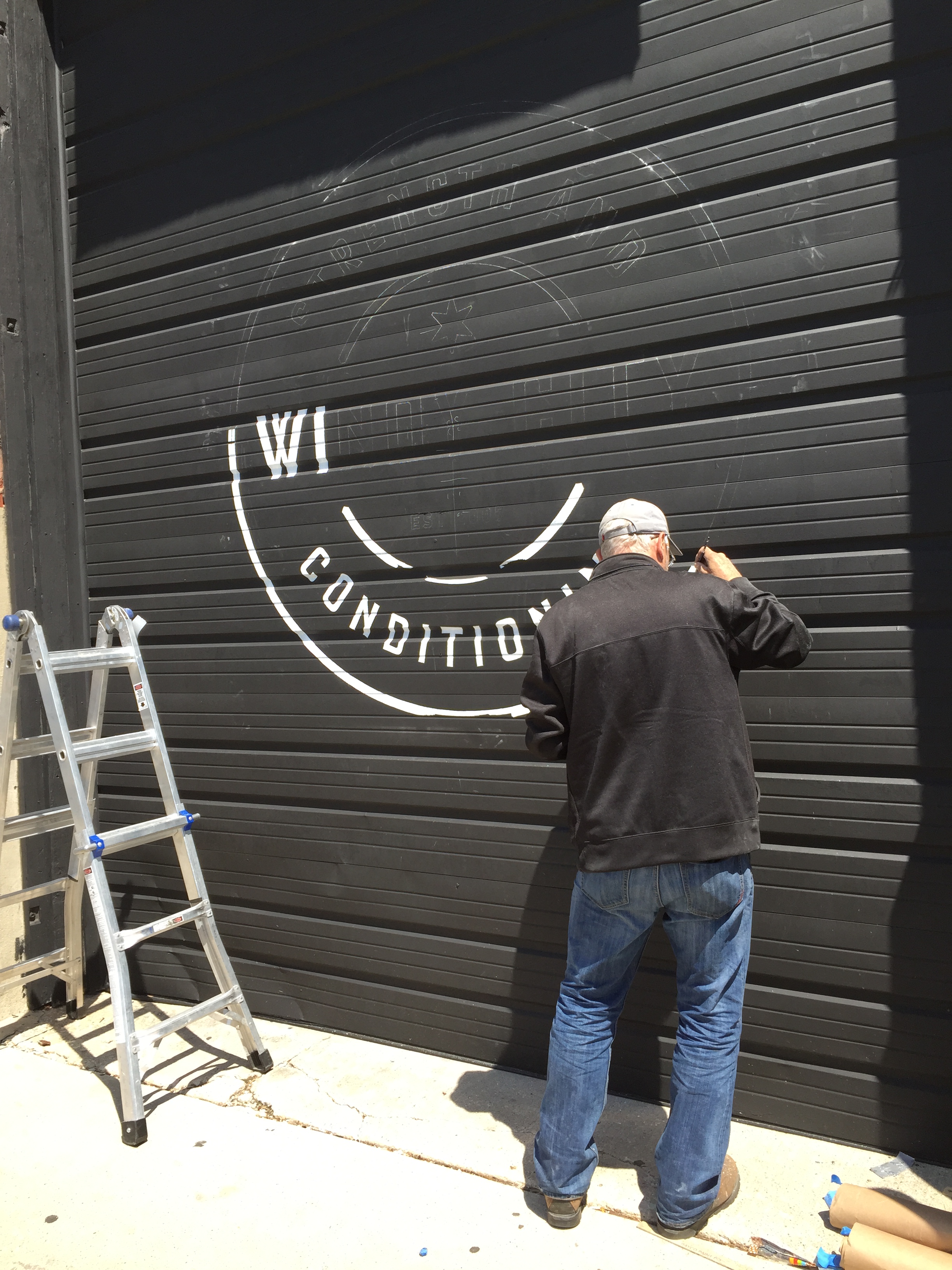 In-Progress Photo of The Custom Sign Painter Hard at Work