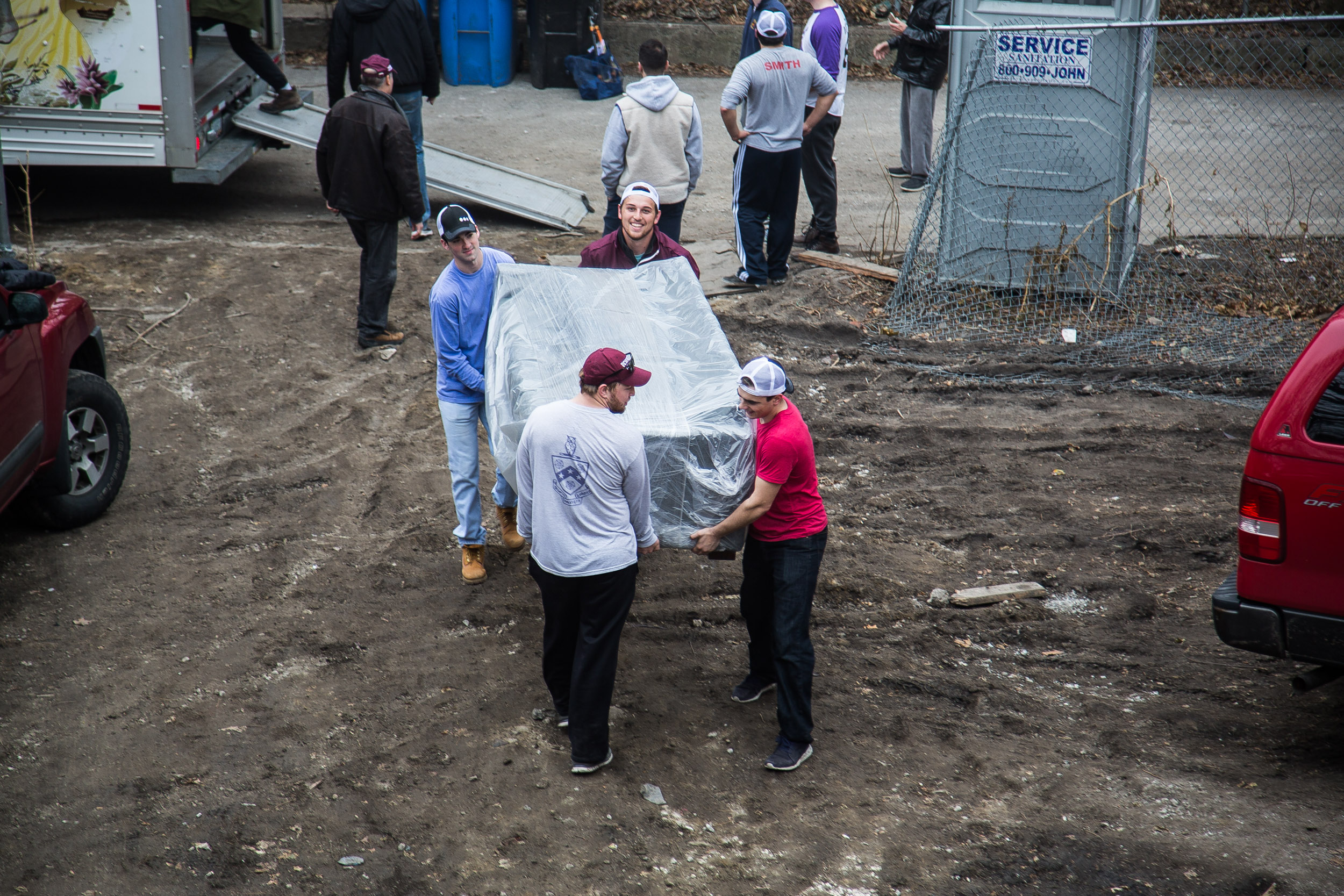 Students leading the charge with the first piece of furniture to make it into the new house