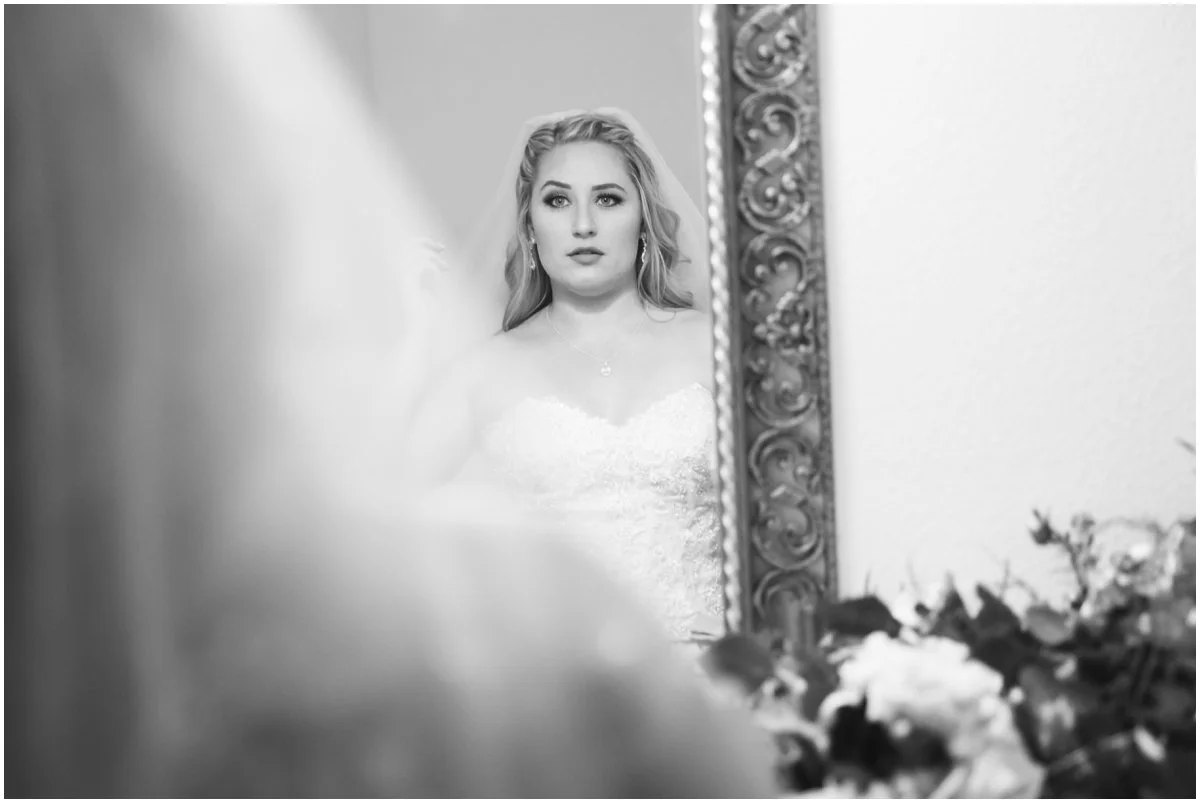 Caitlin adjusts her veil before heading out for portraits.