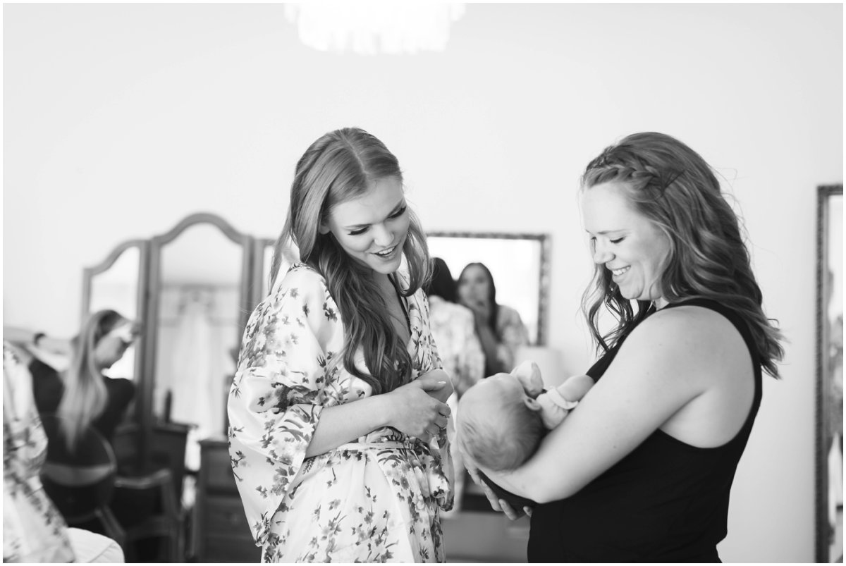 Raquel looks lovingly at her brand new nephew in the bridal suite at Gover Ranch.