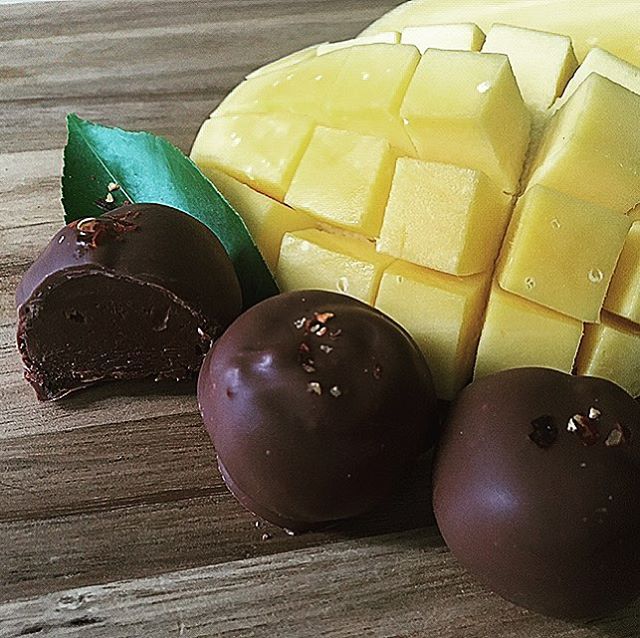 This definitely counts as Farm to kitchen to table! Fresh champagne mango rolled into chocolate ganache, dipped in dark chocolate and finished with 2(or 3) chili flakes. My early spring favorite! . #mango #champagnemango #truffles #darkchocolate #ganache #chocolate #smallbusiness #philadelphia #artisan #handmade #smallbatch #foodpreneur