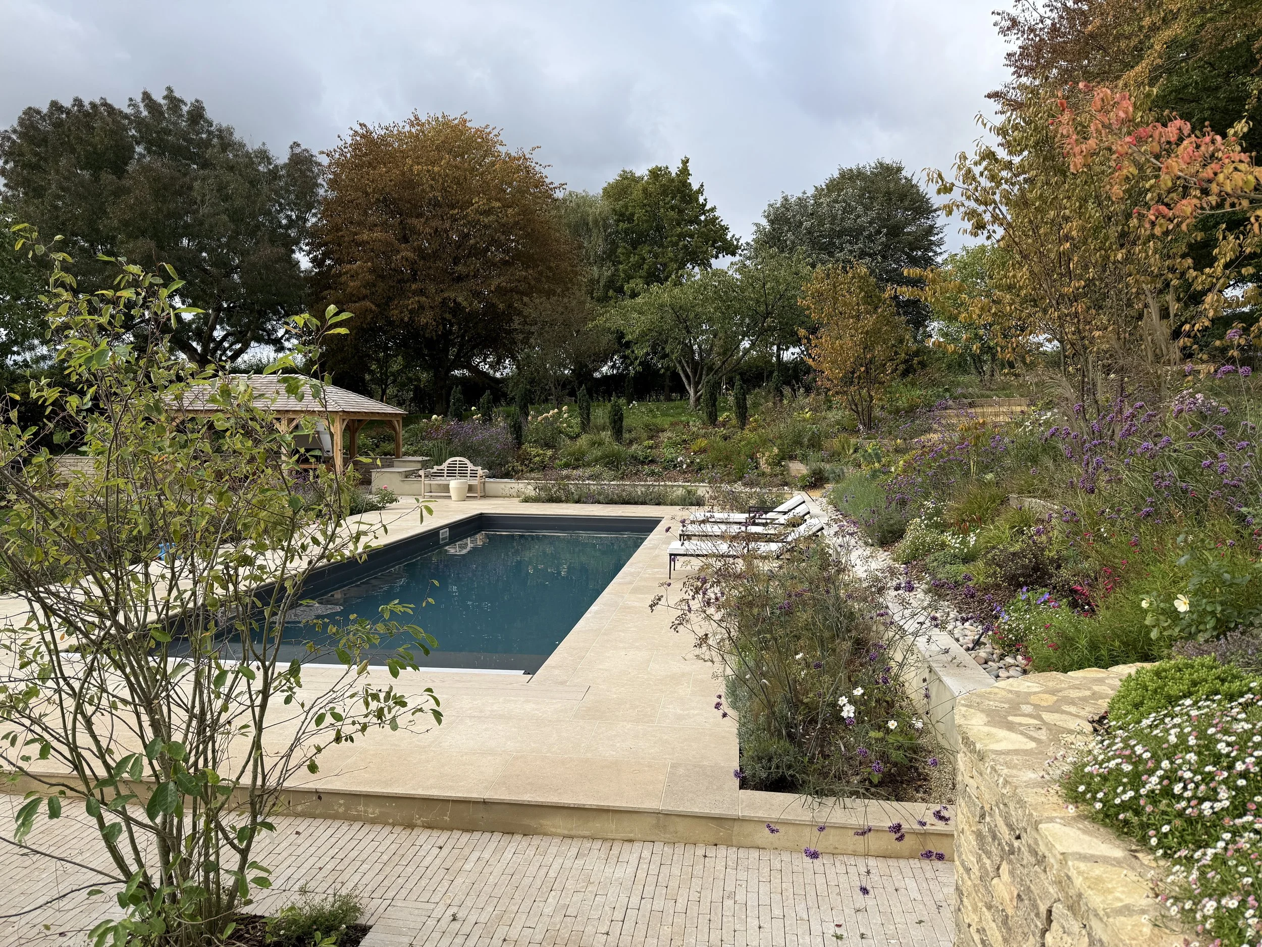 The pool terrace with sloped planting beds from the upper garden