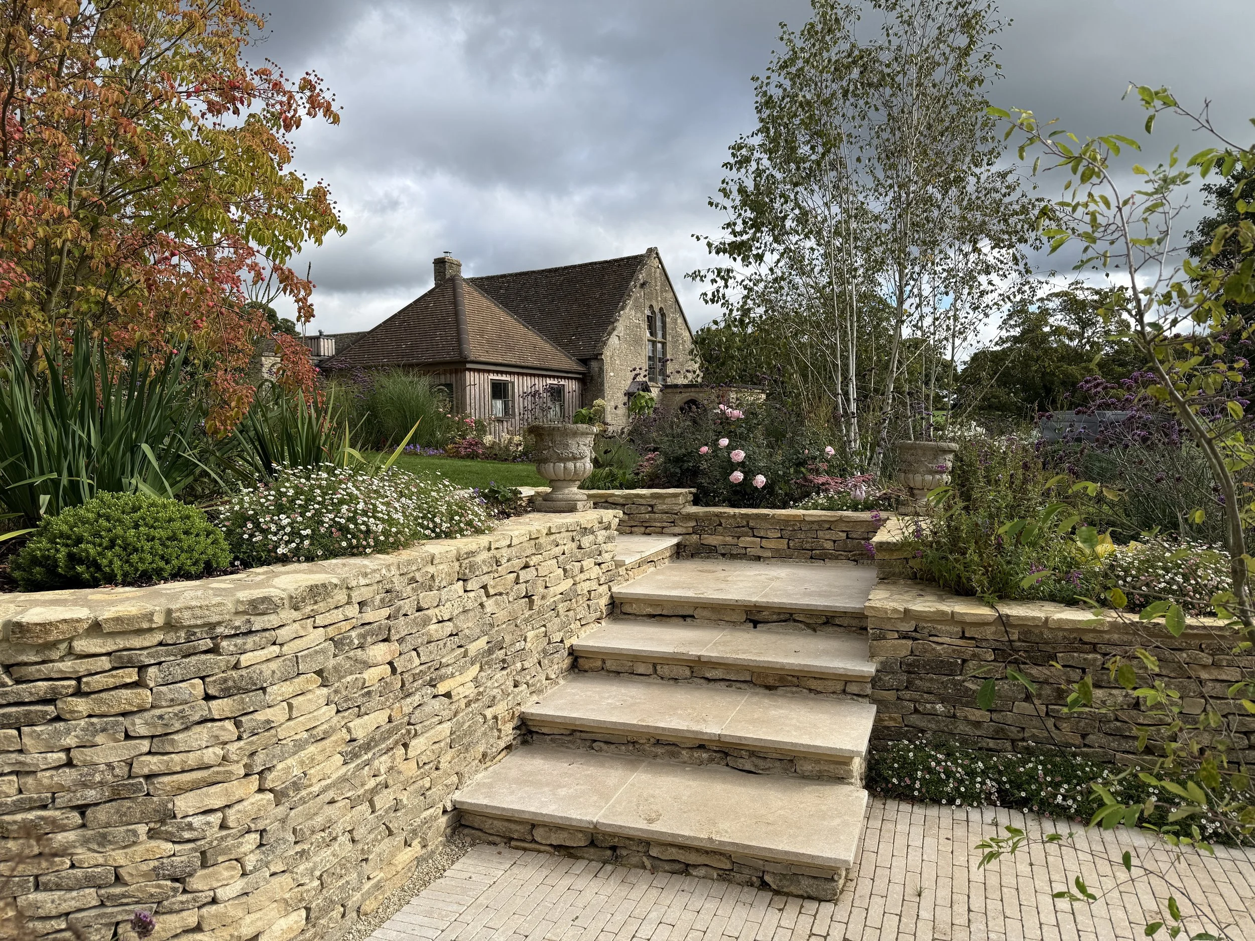 Cotswold stone walls and steps up to the annex garden