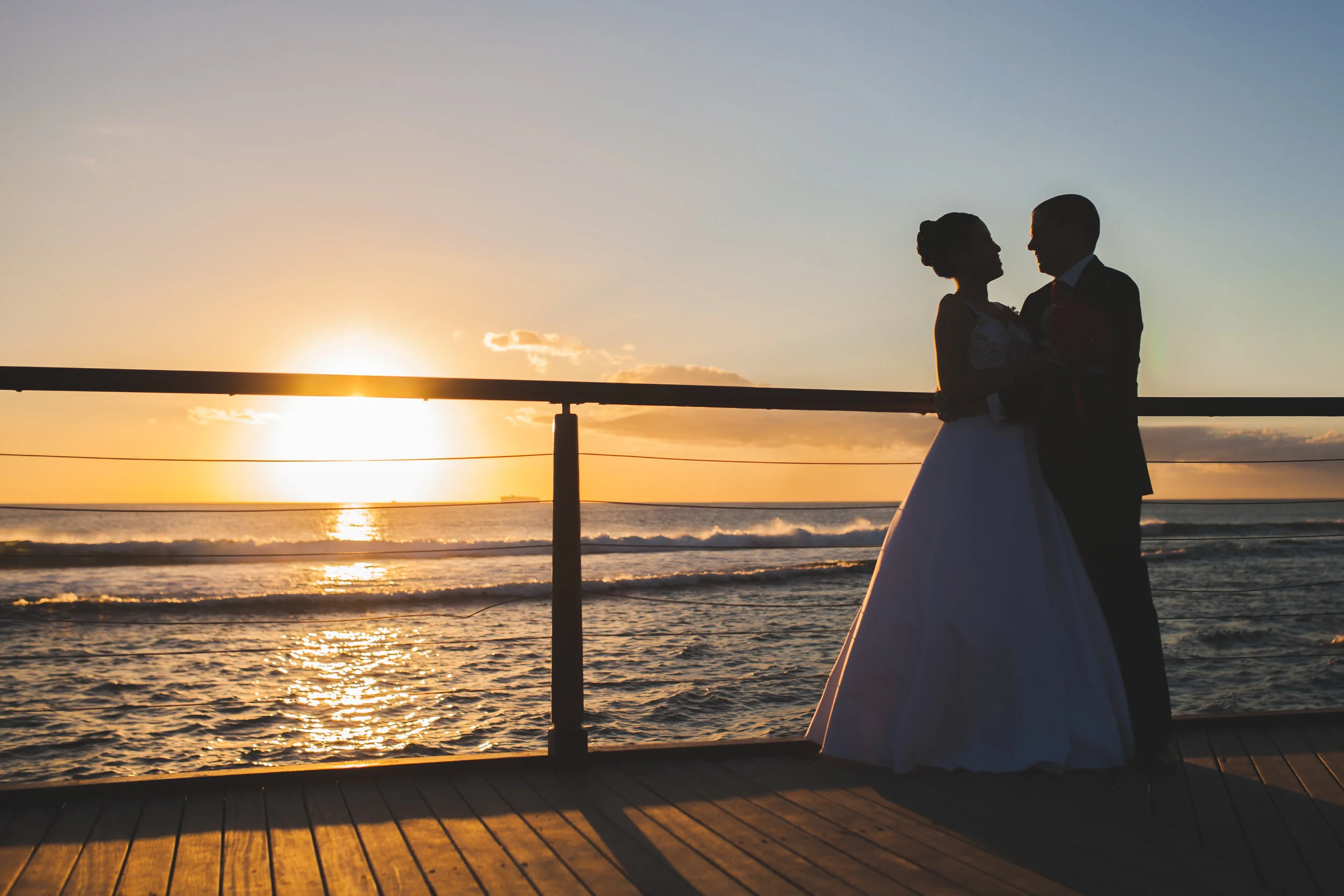 Bride and groom silhouette in front of sunset in Mauritius