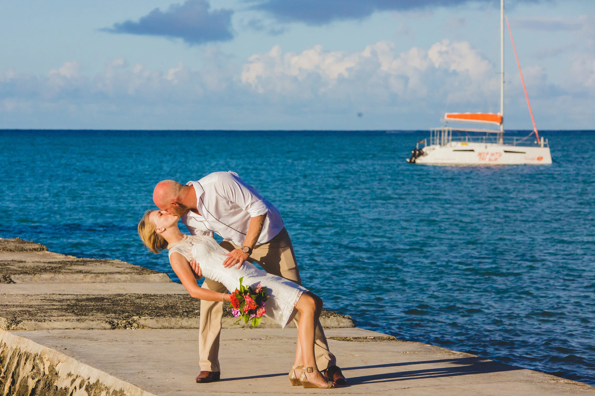 Couple posing in front of boat