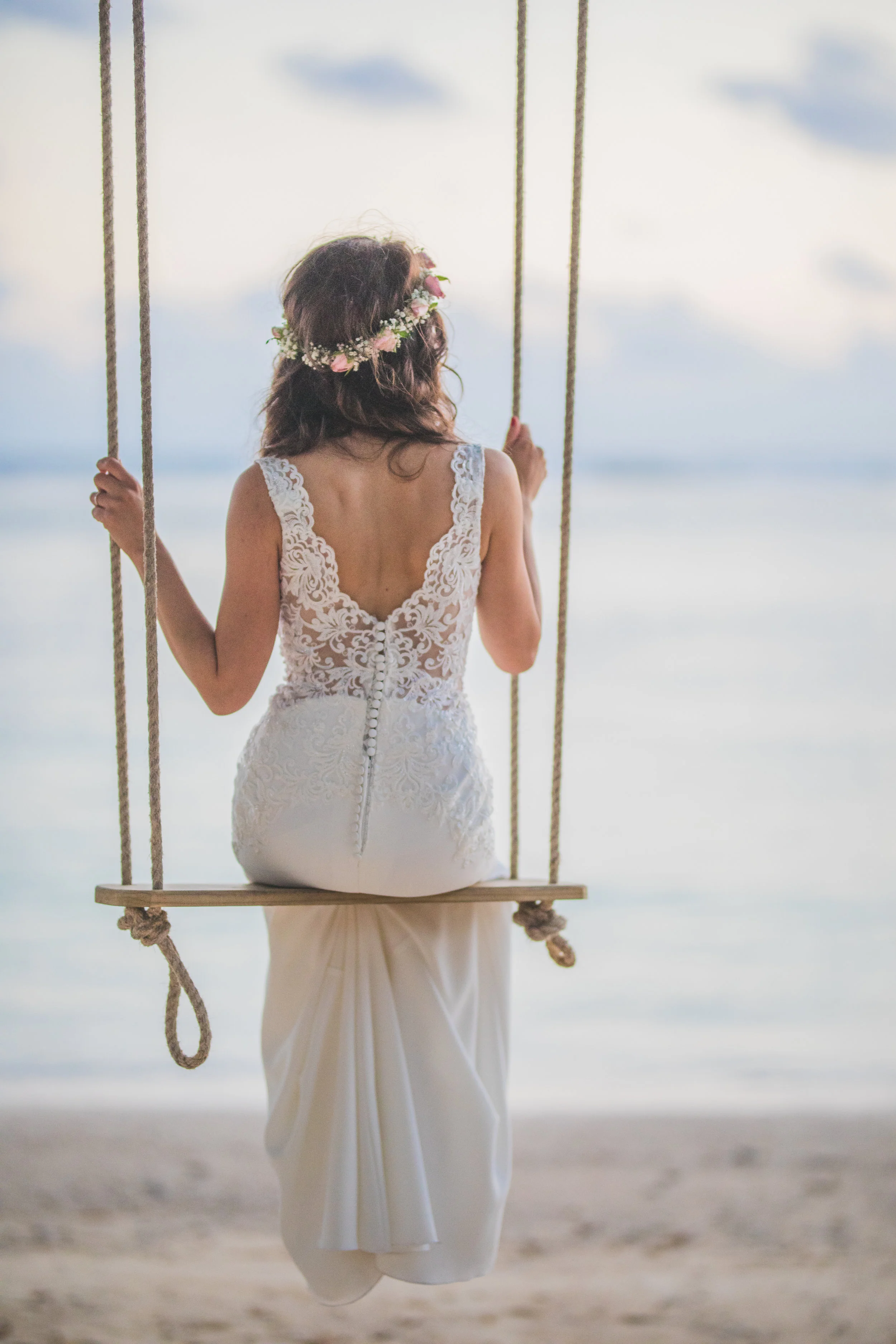 Bride's back on swing looking a Mauritian sea