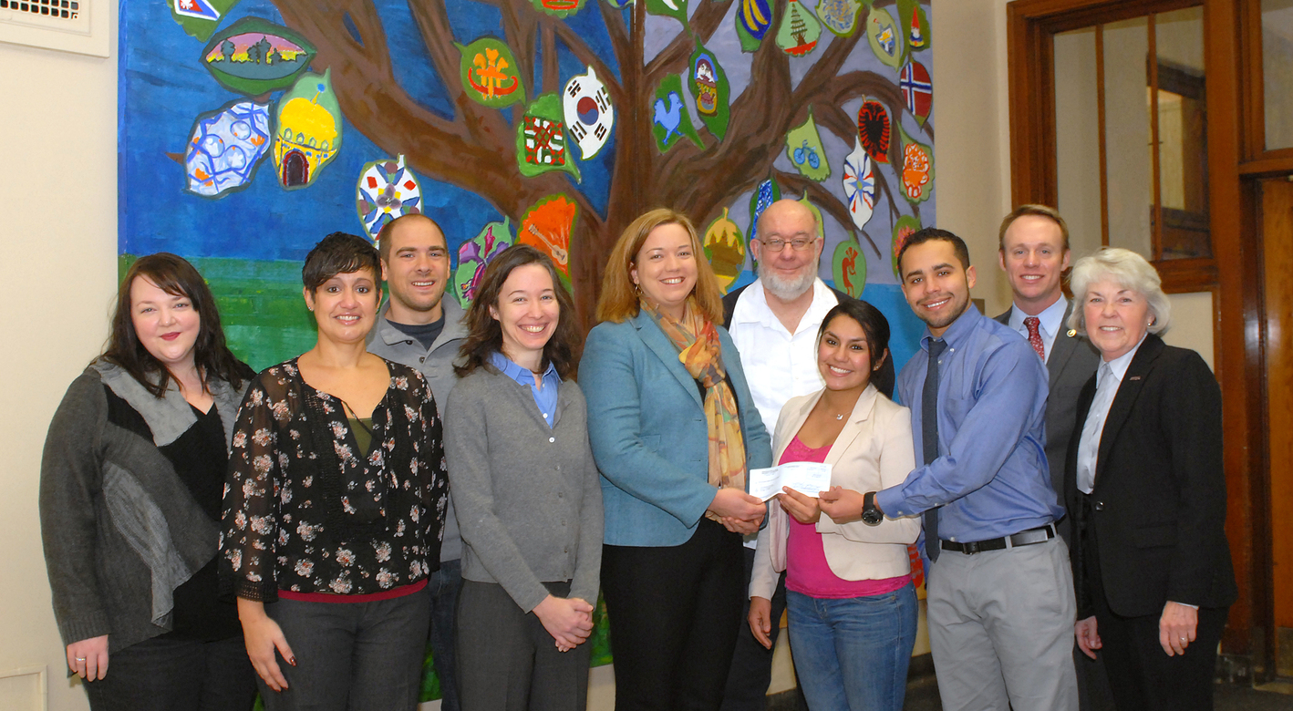 NEIU faculty and students providing a check for $6,080 to FoP for fire victims.