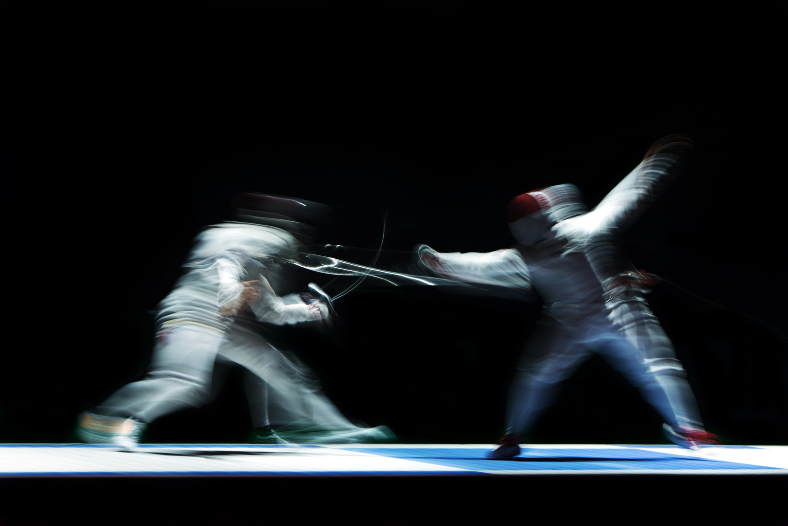 Kevin Jerrold Chan (R) of Singapore in action against Wilfred Richard Curioso of the Philippines during the men's team foil finals of the fencing competition at the 28th Southeast Asian Games at the OCBC Arena on June 7, 2015 in Singapore.