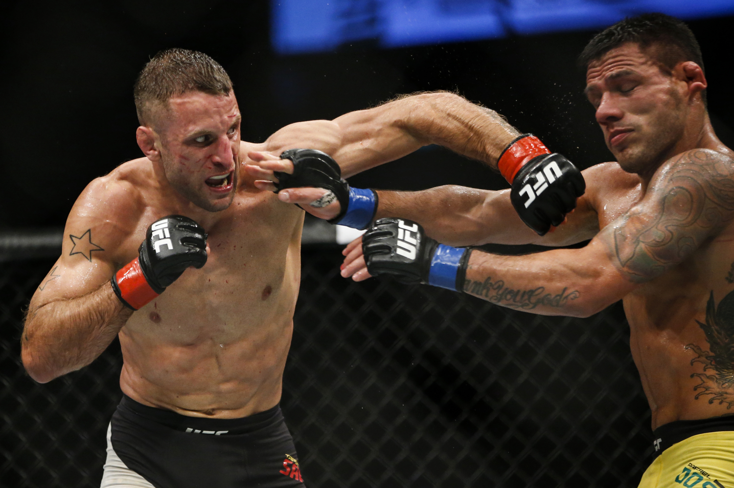  Tarec Saffiedine of Belgium (L) punches Rafael dos Anjos of Brazil during their welterweight bout at the UFC Fight Night at the Singapore Indoor Stadium on June 17, 2017. 