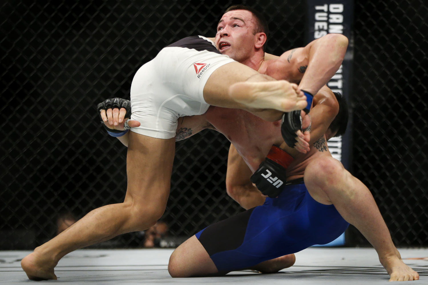 Colby Covington (R) of the United States fights with Dong Hyun Kim of South Korea during their welterweight bout at the UFC Fight Night at the Singapore Indoor Stadium on June 17, 2017.