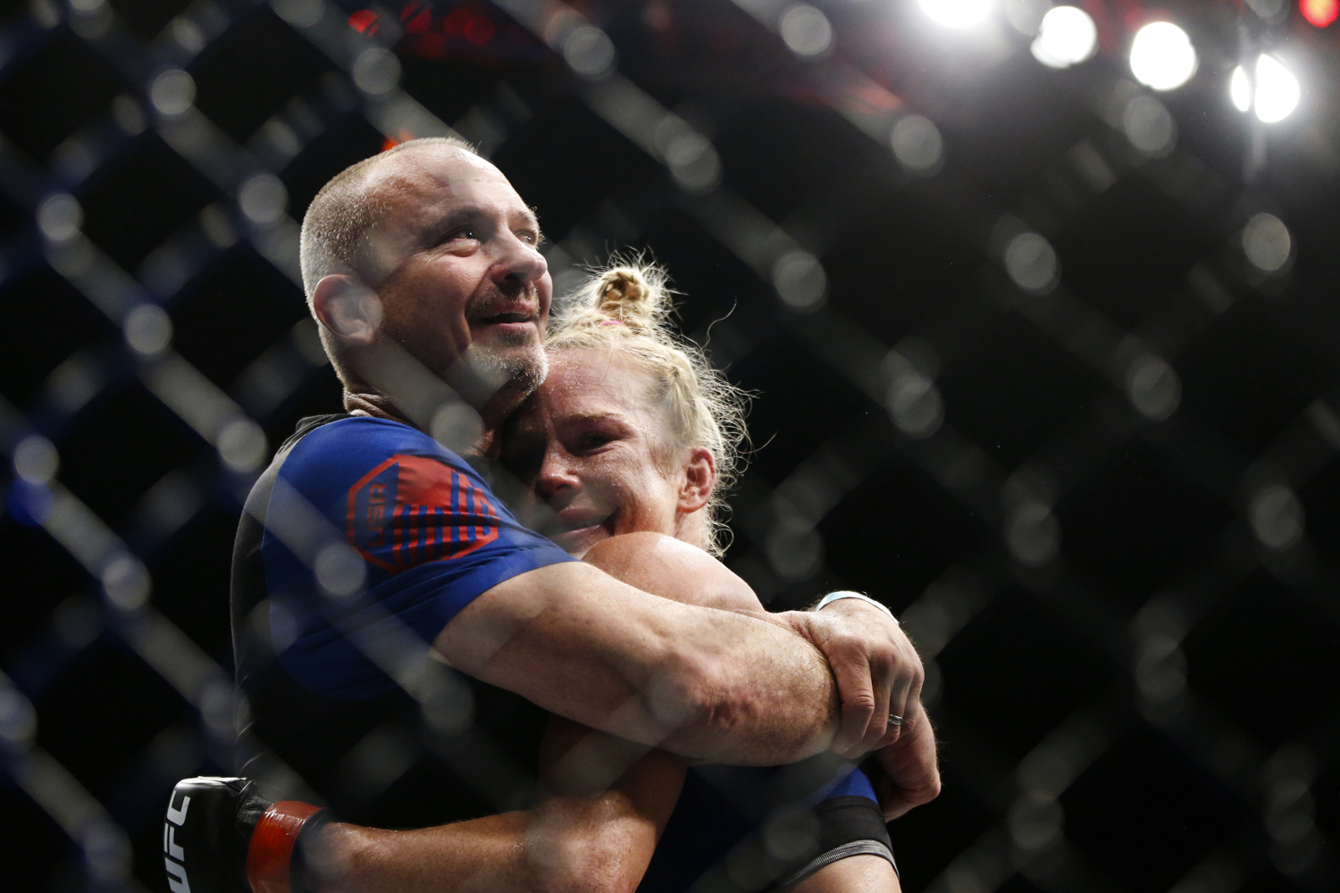  Holly Holm of the United States celebrates her bantamweight bout win over Bethe Correia of Brazil with her coach Greg Jackson at the UFC Fight Night at the Singapore Indoor Stadium on June 17, 2017. 