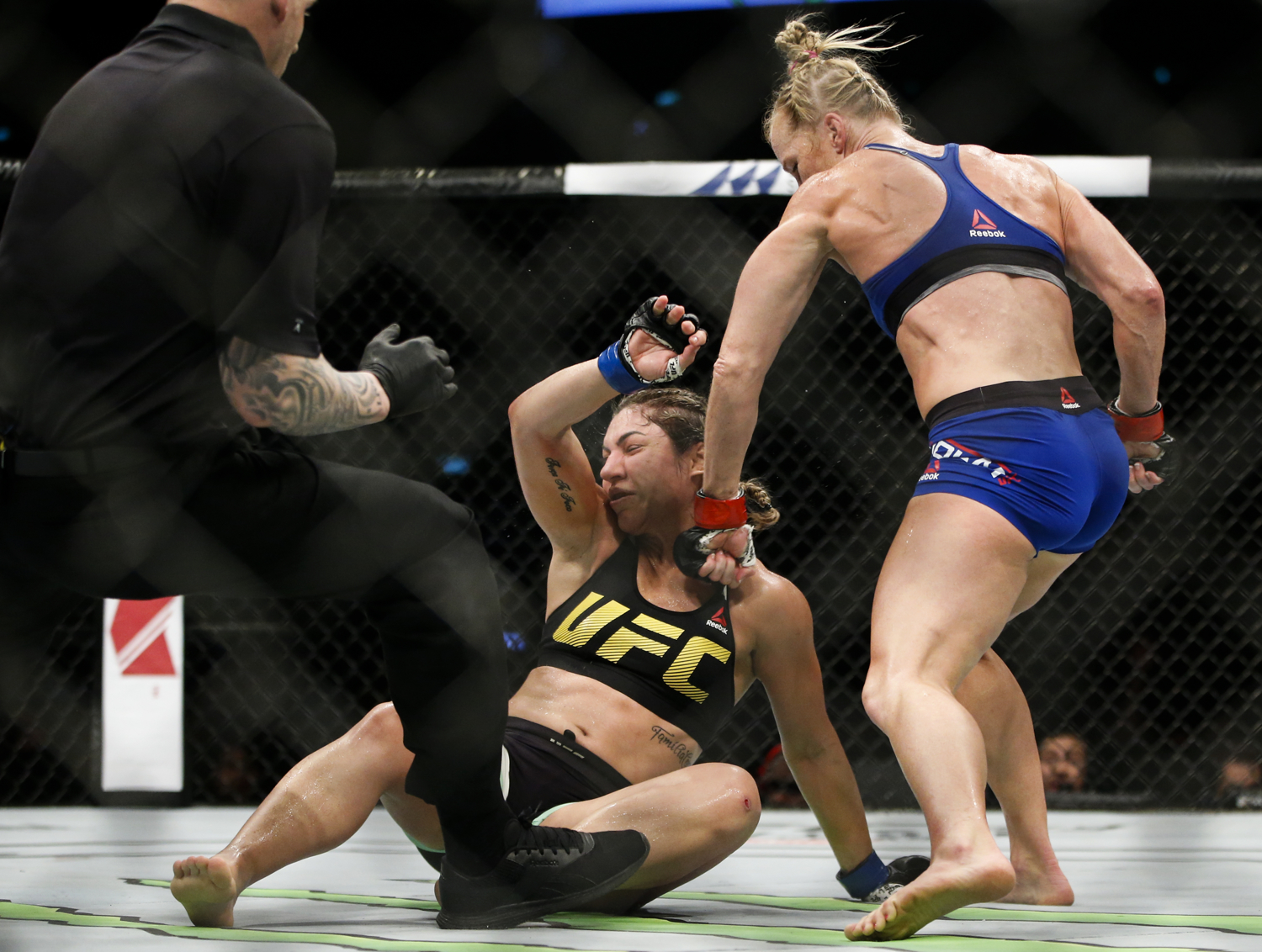 Holly Holm (R) of the United States punches Bethe Correia of Brazil during their bantamweight bout at the UFC Fight Night at the Singapore Indoor Stadium on June 17, 2017. 