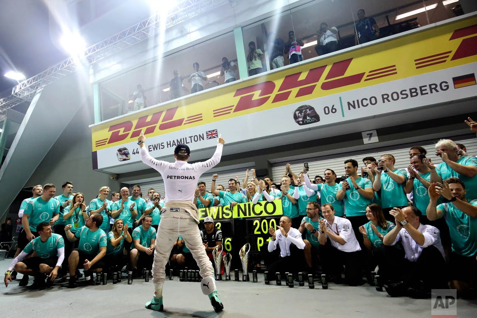 Mercedes driver Nico Rosberg of Germany celebrates with his team after winning the Singapore Formula One Grand Prix on the Marina Bay City Circuit Singapore, Sunday, Sept. 18, 2016. (AP Photo/Yong Teck Lim)
