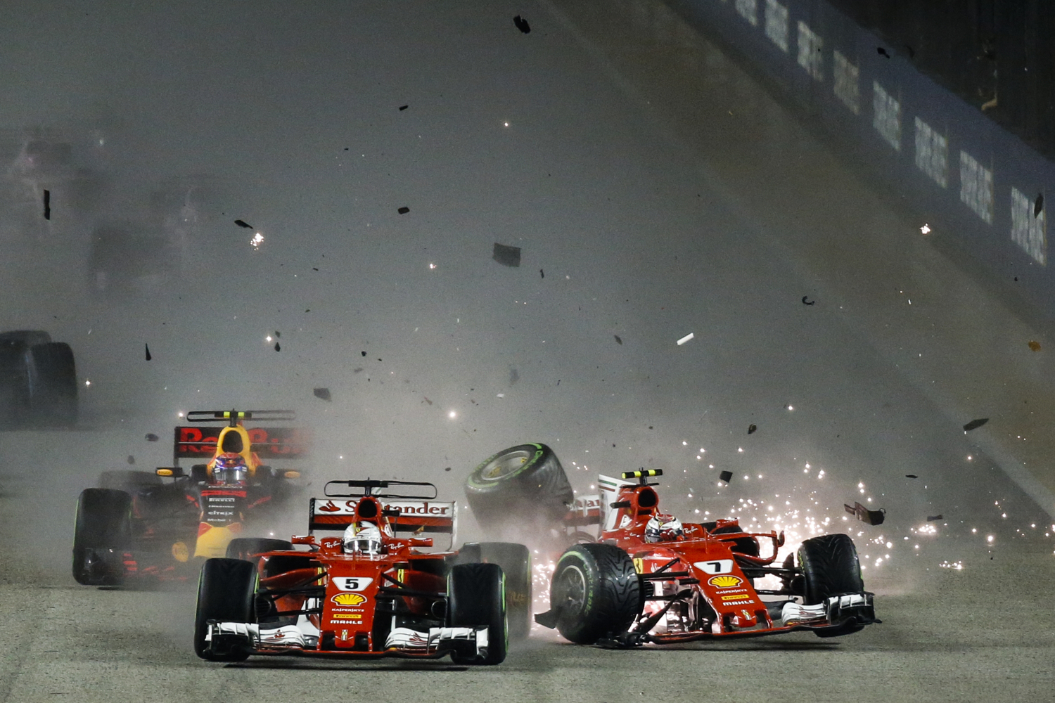  Ferrari driver Kimi Raikkonen, right, of Finland collides with teammate Sebastian Vettel of Germany at the start of the Singapore Formula One Grand Prix on the Marina Bay City Circuit Singapore, Sunday, Sept. 17, 2017. (AP Photo/Yong Teck Lim) 