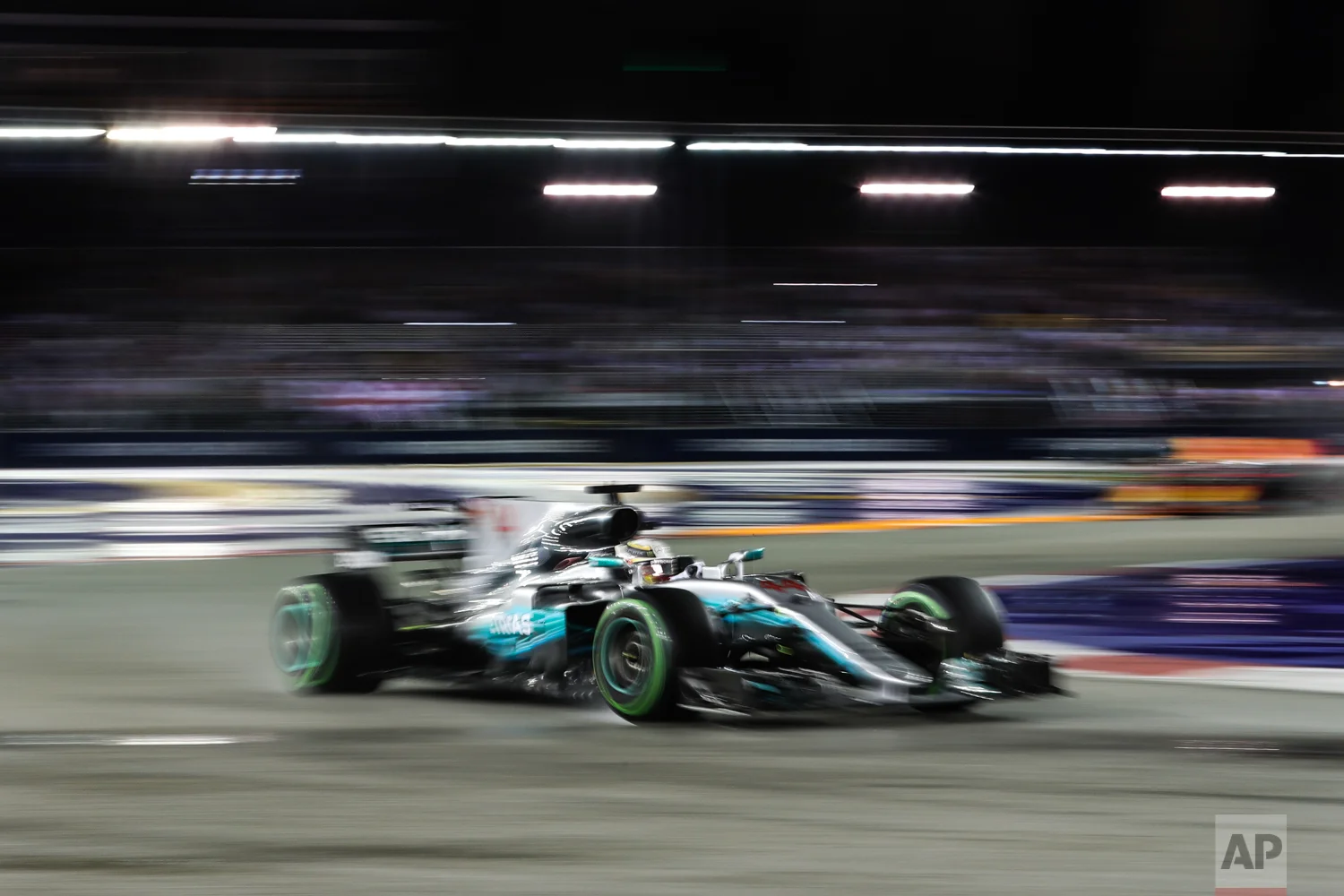 Mercedes driver Lewis Hamilton of Britain steers his car during the Singapore Formula One Grand Prix on the Marina Bay City Circuit Singapore, Sunday, Sept. 17, 2017. (AP Photo/Yong Teck Lim)
