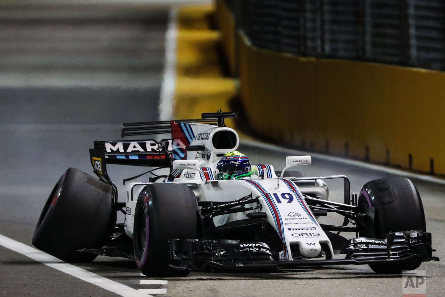  Williams driver Felipe Massa of Brazil steers his car with the rear wheel damaged after hitting the wall during the qualifying session for the Singapore Formula One Grand Prix on the Marina Bay City Circuit Singapore, Saturday, Sept. 16, 2017. (AP P