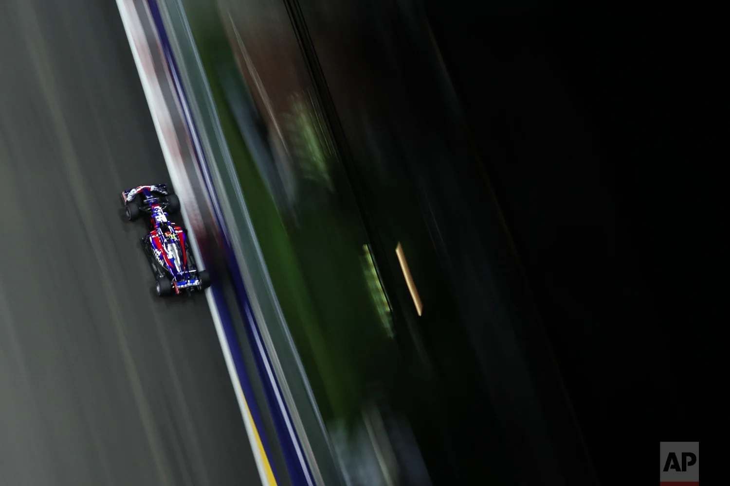Toro Rosso driver Carlos Sainz Jr.of Spain steers his car during the second practice session at the Singapore Formula One Grand Prix on the Marina Bay City Circuit Singapore, Friday, Sept. 15, 2017. (AP Photo/Yong Teck Lim)