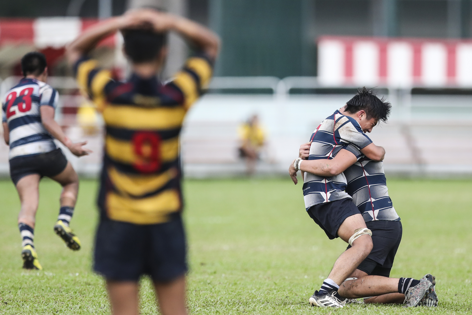 Marcus Chan and James Batt (right) of St. Andrew’s Secondary School celebrate their win against Anglo-Chinese School (Independent) during the National Schools boys’ ‘B’ Division rugby final at Queenstown Stadium on March 28, 2018 in Singapore. (Photo © Yong Teck Lim/Red Sports)