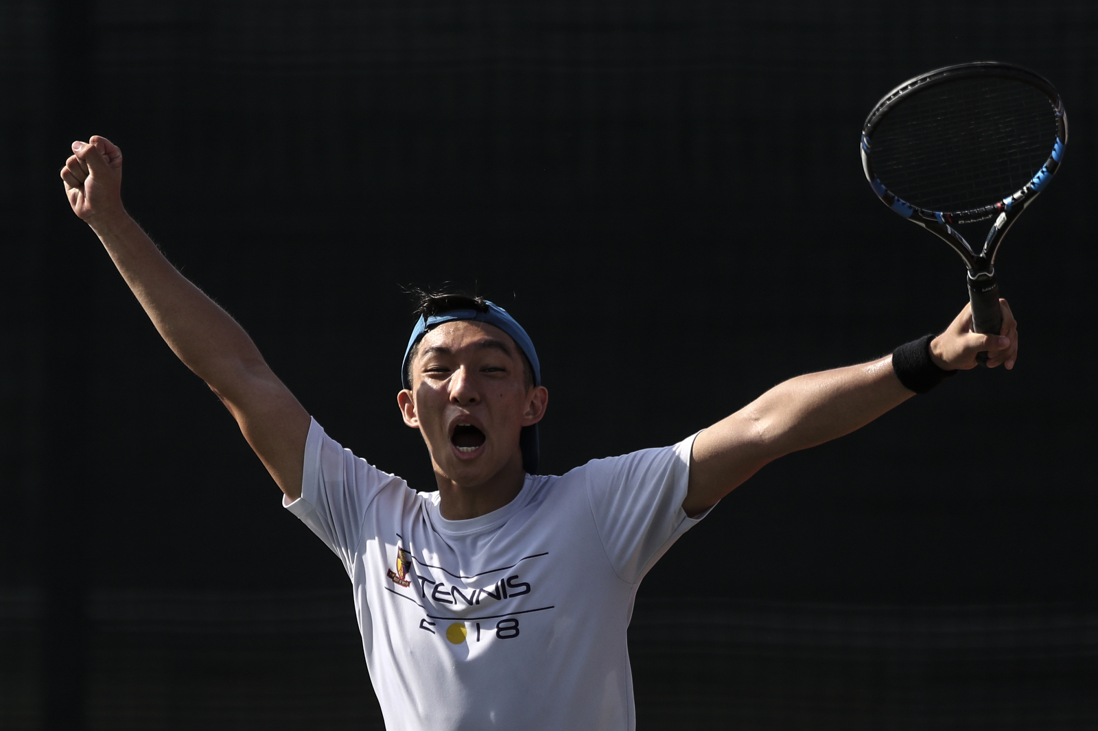 Oliver Loo of Anglo-Chinese School (Independent) celebrates his doubles match victory against Raffles Institution during the National Schools boys’ ‘A' Division tennis final at Kallang Tennis Centre on May 9, 2018 in Singapore. (Photo © Yong Teck Lim/Red Sports)