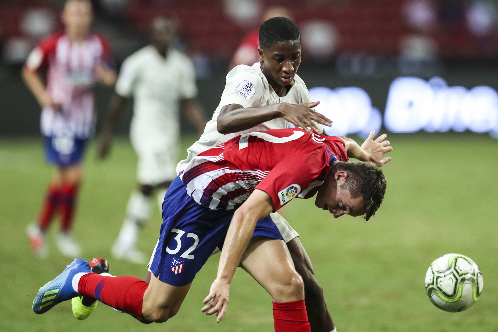  Atletico Madrid’s Borja Garces, bottom, is fouled by Paris Saint-Germain’s Moussa Sissako during the International Champions Cup match between Paris Saint-Germain and Atletico Madrid in Singapore, Monday, July 30, 2018. (AP Photo/Yong Teck Lim) 