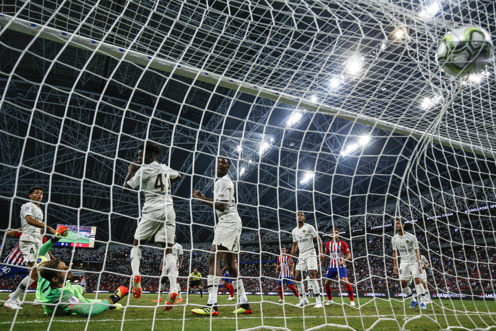  Atletico Madrid’s Victor Mollejo, left, scores their first goal during the International Champions Cup match between Paris Saint-Germain and Atletico Madrid in Singapore, Monday, July 30, 2018. (AP Photo/Yong Teck Lim) 