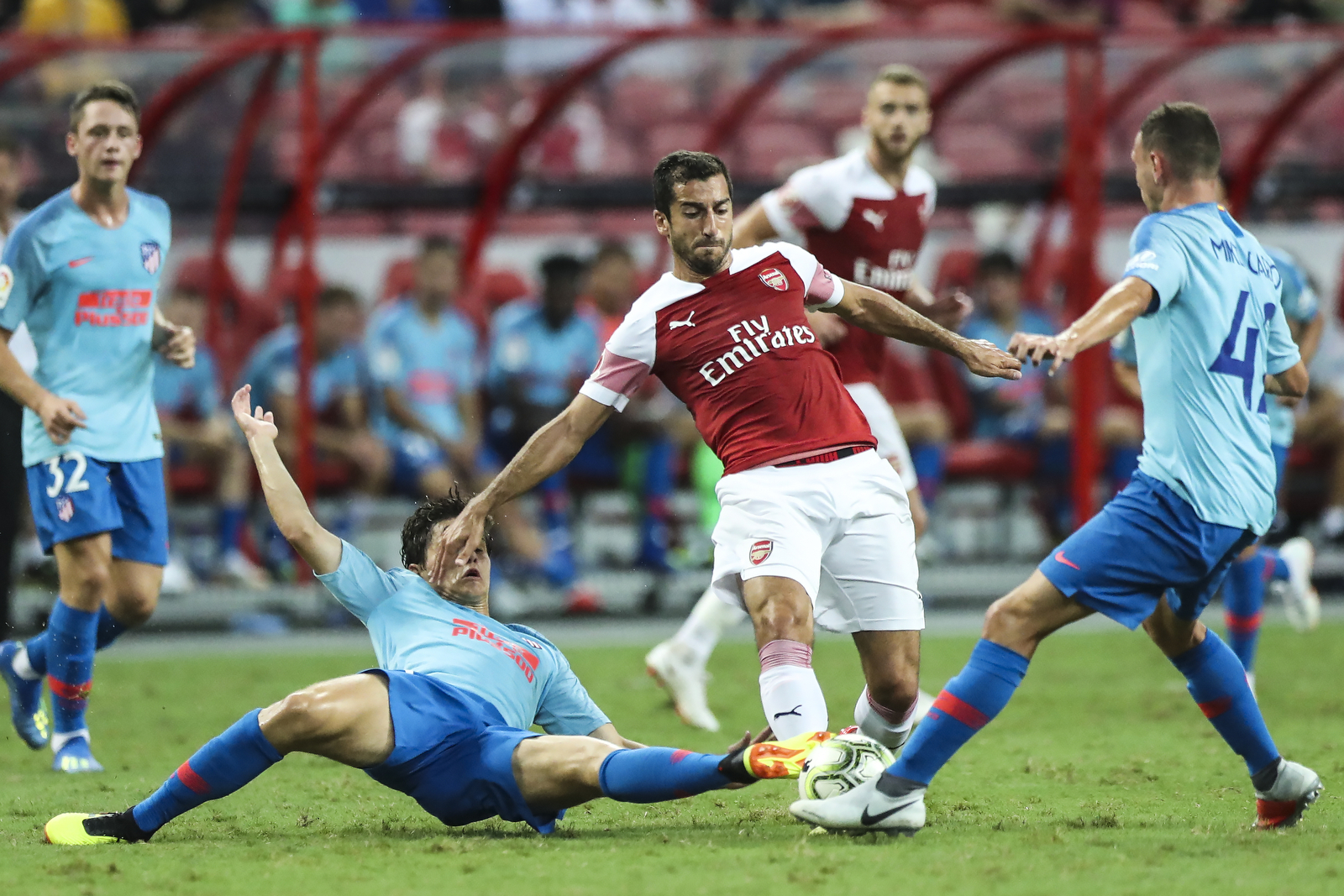  Arsenal’s Henrikh Mkhitaryan, center, controls the ball against Atletico Madrid’s Andres Solano, left, and Mikel Carro during the International Champions Cup match between Arsenal and Atletico Madrid in Singapore, Thursday, July 26, 2018. (AP Photo/