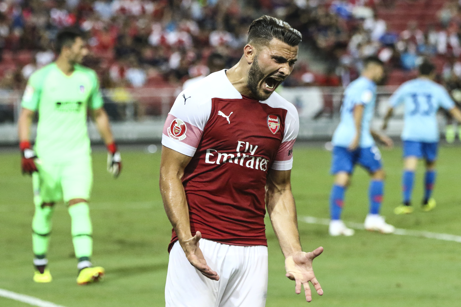  Arsenal’s Sead Kolasinac reacts after missing a shot attempt during the International Champions Cup match between Arsenal and Atletico Madrid in Singapore, Thursday, July 26, 2018. (AP Photo/Yong Teck Lim) 