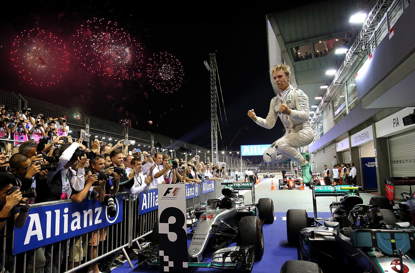  Mercedes driver Nico Rosberg of Germany jumps off his car as he celebrates after winning the Singapore Formula One Grand Prix on the Marina Bay City Circuit Singapore, Sunday, Sept. 18, 2016. (AP Photo/Yong Teck Lim) 