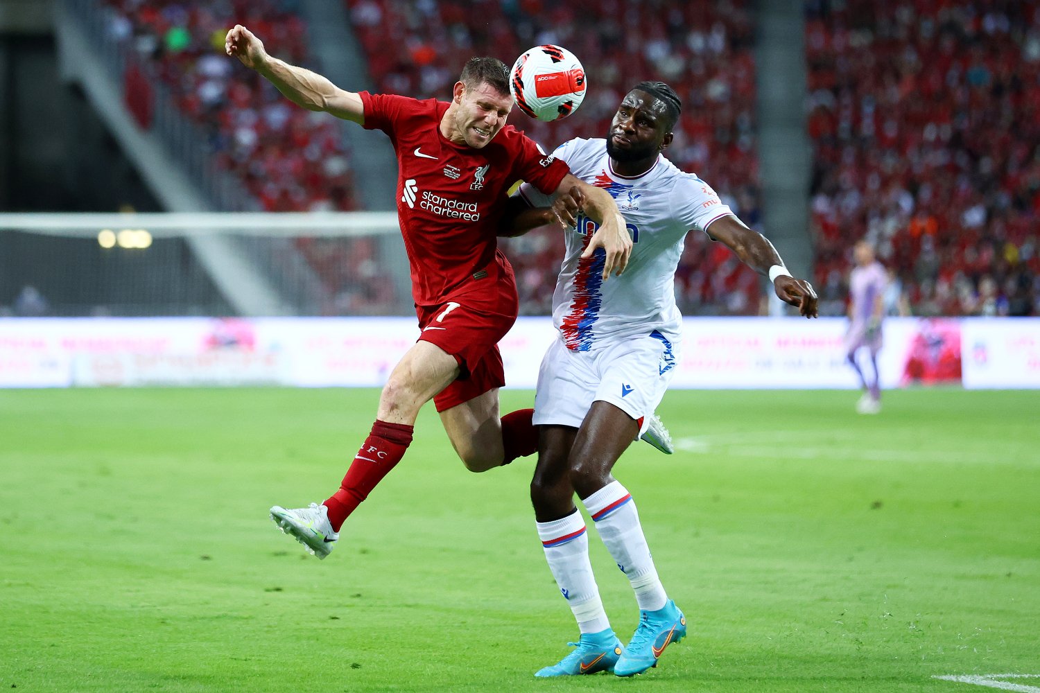 SINGAPORE, SINGAPORE - JULY 15: James Milner #7 of Liverpool heads the ball against Odsonne Edouard #22 of Crystal Palace during the first half of their preseason friendly at the National Stadium on July 15, 2022 in Singapore. (Photo by Yong Teck Li