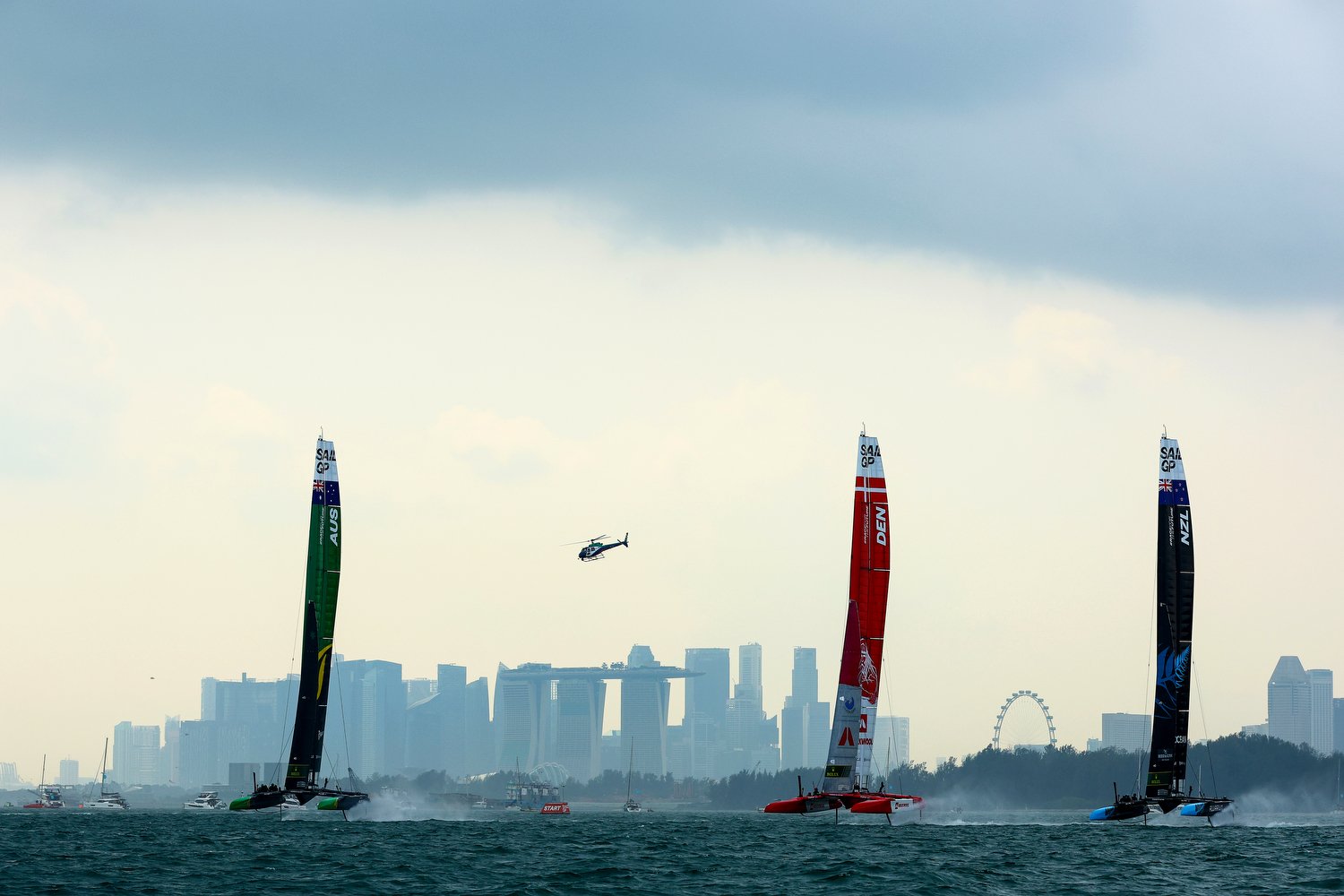  SINGAPORE, SINGAPORE - JANUARY 15: (L-R) Team Australia, driven by Tom Slingsby, Team Denmark, driven by Nicolai Sehested, and Team New Zealand, driven by Peter Burling, compete in the final race during race day 2 of the Singapore Sail Grand Prix at