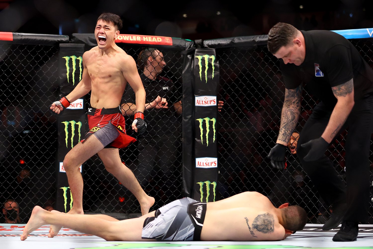  SINGAPORE, SINGAPORE - JUNE 12: Hayisaer Maheshate of China celebrates after knocking out Steve Garcia of the United States in their lightweight bout during UFC 275 at Singapore Indoor Stadium on June 12, 2022 in Singapore. (Photo by Yong Teck Lim/G