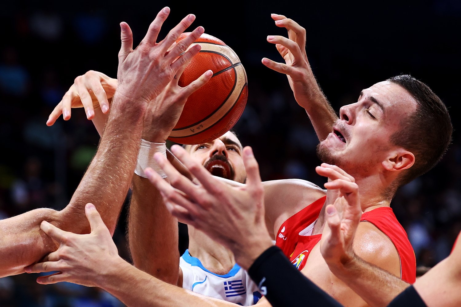  MANILA, PHILIPPINES - SEPTEMBER 03: Emmanouil Chatzidakis #76 of Greece competes for a loose ball against Marko Simonovic #19 of Montenegro in the third quarter during the FIBA Basketball World Cup 2nd Round Group J game at Mall of Asia Arena on Sep