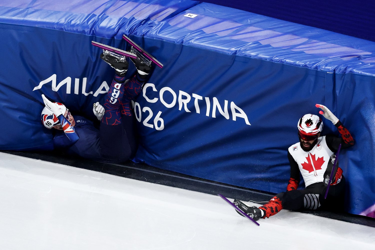  MILAN, ITALY - FEBRUARY 10: Niall Treacy of Team Great Britain and Steven Dubois of Team Canada crash in heat 4 of the Short Track Speed Skating Men's 1000m on day four of the Milano Cortina 2026 Winter Olympic games at Milano Ice Skating Arena on F