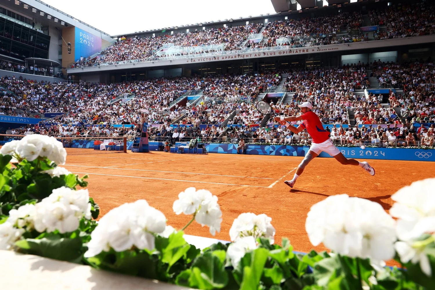  PARIS, FRANCE - AUGUST 04: Novak Djokovic of Team Serbia plays a backhand during the Men's Singles Gold medal match against Carlos Alcaraz of Team Spain on day nine of the Olympic Games Paris 2024 at Roland Garros on August 04, 2024 in Paris, France
