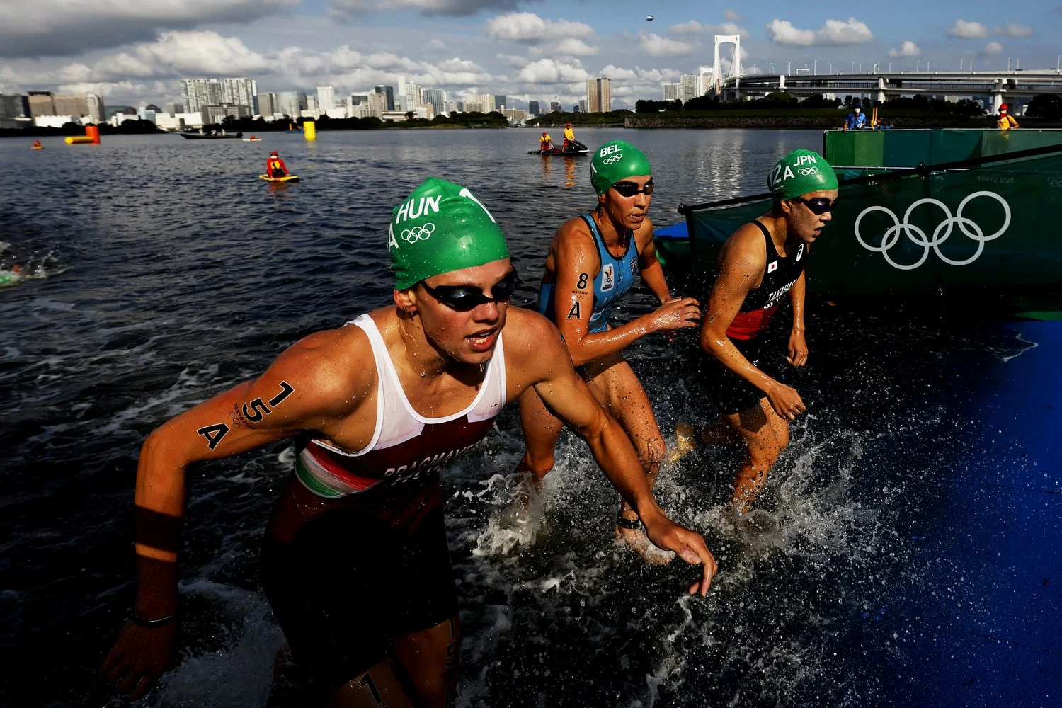  TOKYO, JAPAN - JULY 31: Zsanett Bragmayer of Team Hungary, Claire Michel of Team Belgium and Yuko Takahashi of Team Japan compete during the Mixed Relay Triathlon on day eight of the Tokyo 2020 Olympic Games at Odaiba Marine Park on July 31, 2021 in