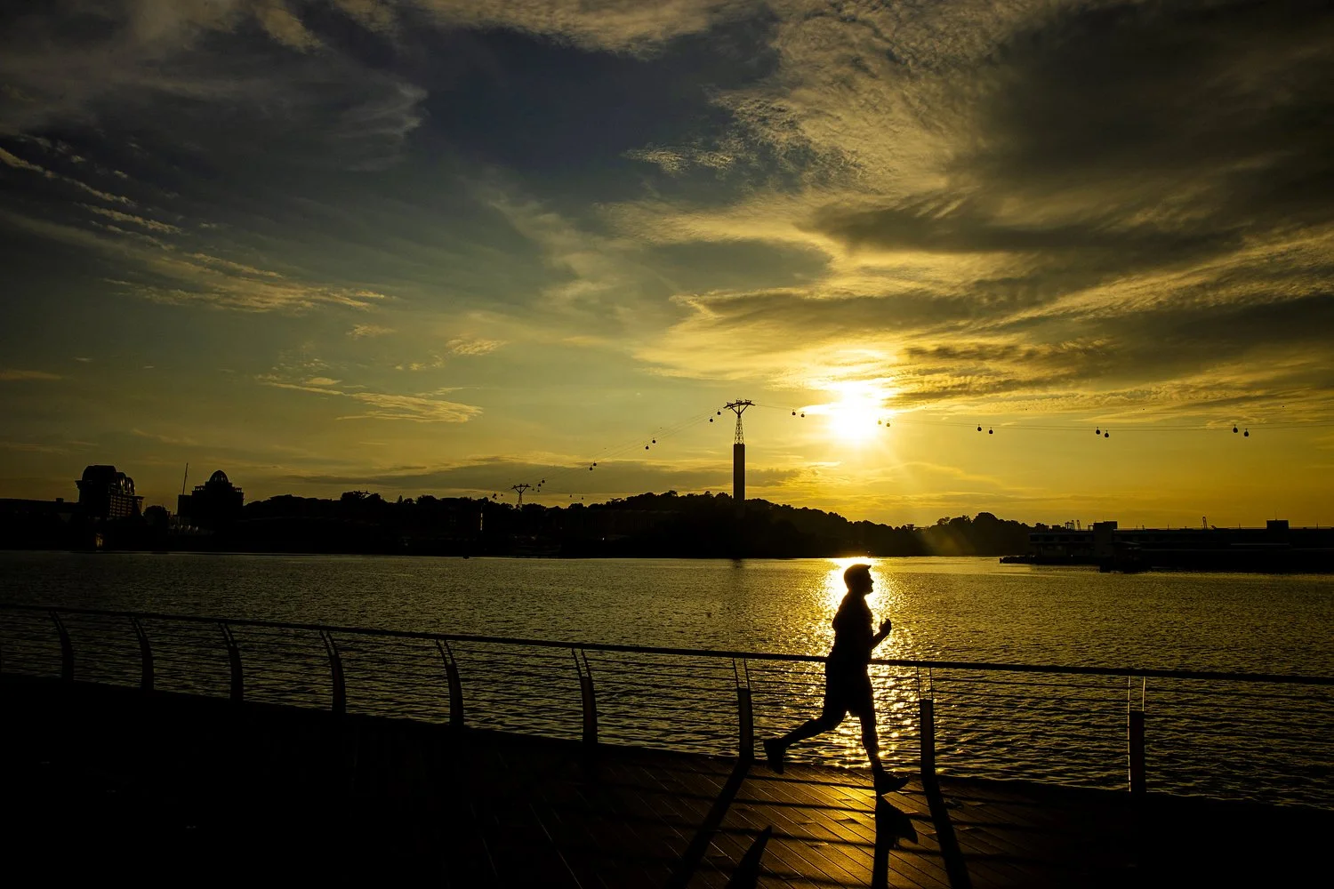  A person runs along the Sentosa Boardwalk during sunset as the COVID-19 lockdown continues on December 23, 2020 in Singapore. 