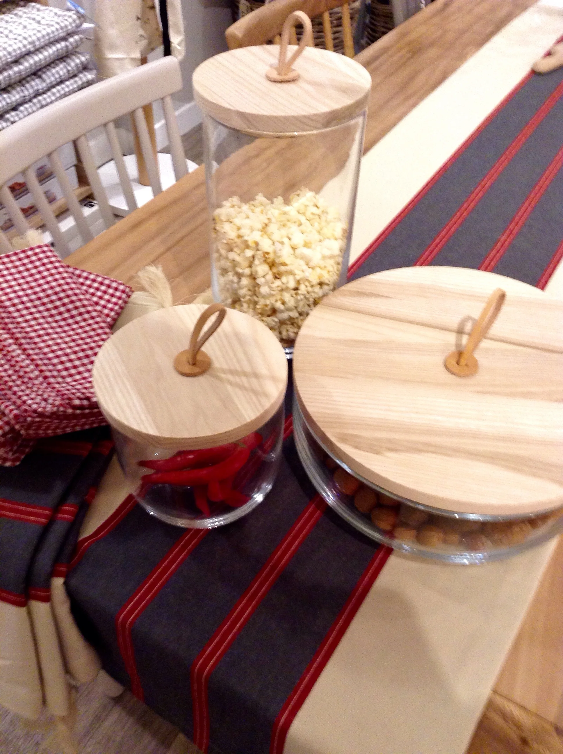 3 beautiful storage jars, hand blown glass with ash lids & leather loop handles. S £29.00, M £39.00, L £65.00 Cotton gingham napkins £19.00 for 4, (also available in dark grey). Cotton runner for very long tables (240cm) £45.00.