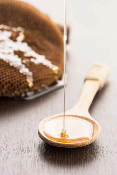 2028446-closeup-honey-drop-on-spoon-healthy-food-concept.jpg