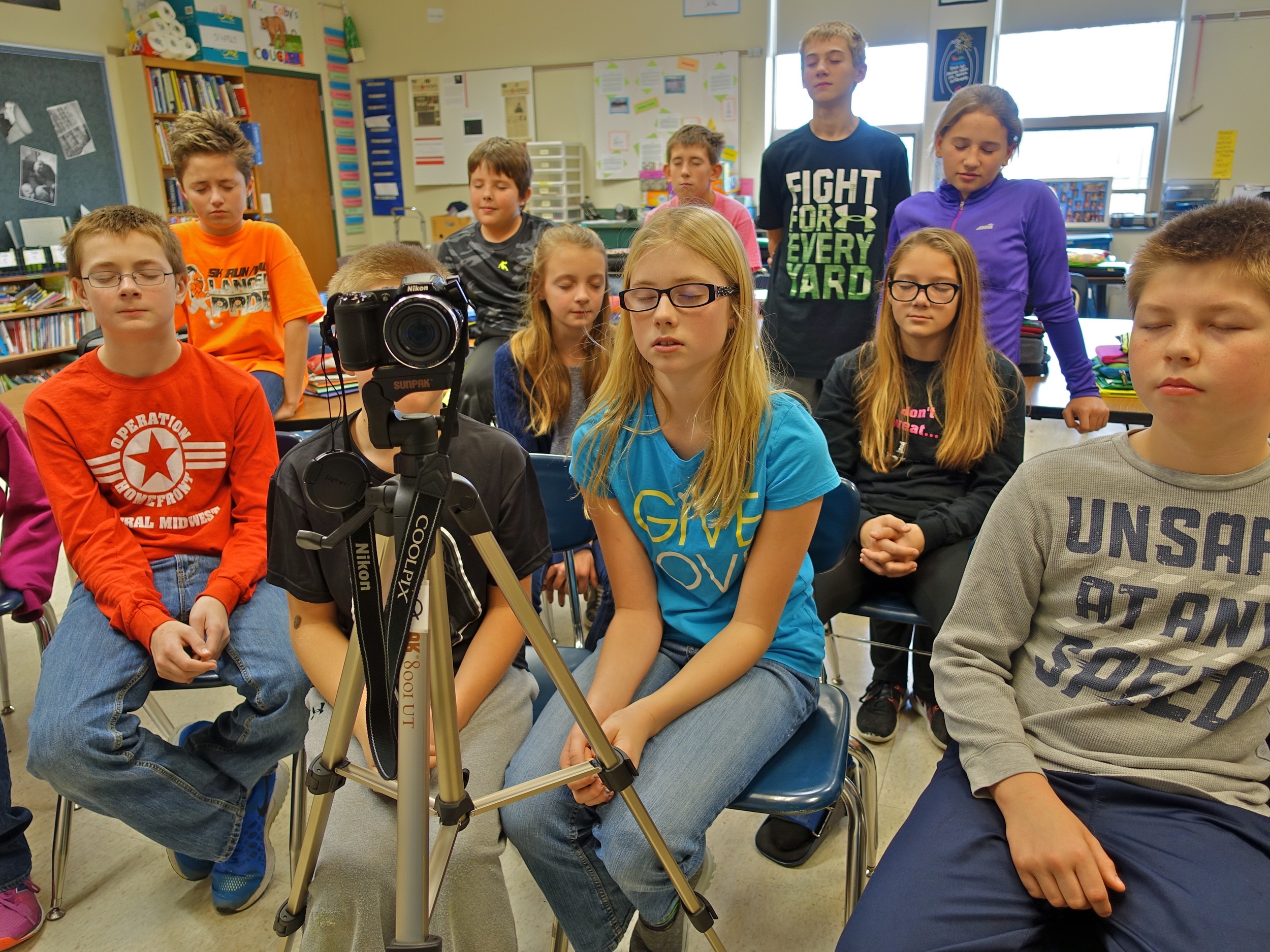 Students listening to the camera, photo by Mike Hazard